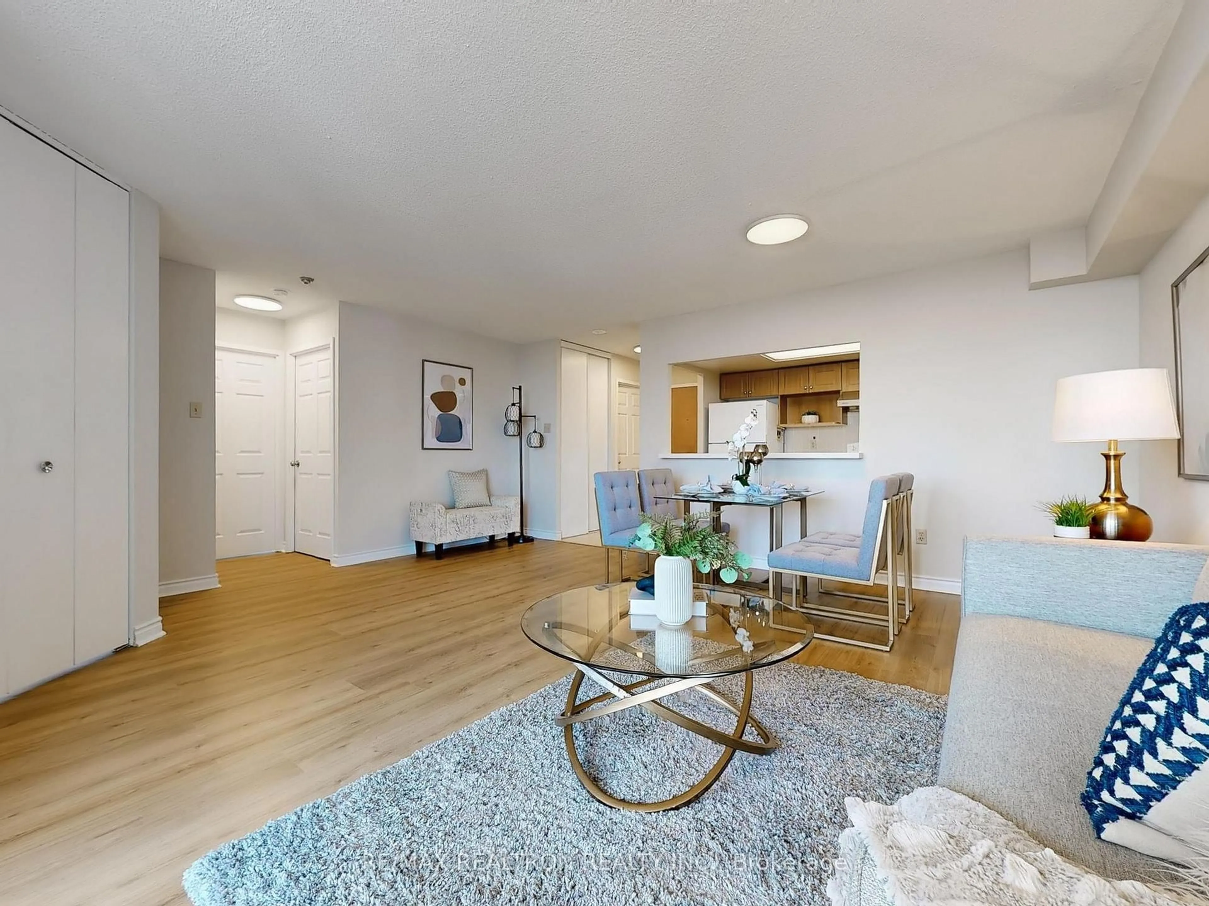 Living room with furniture, wood/laminate floor for 88 Alton Tower Circ #905, Toronto Ontario M1V 5C5