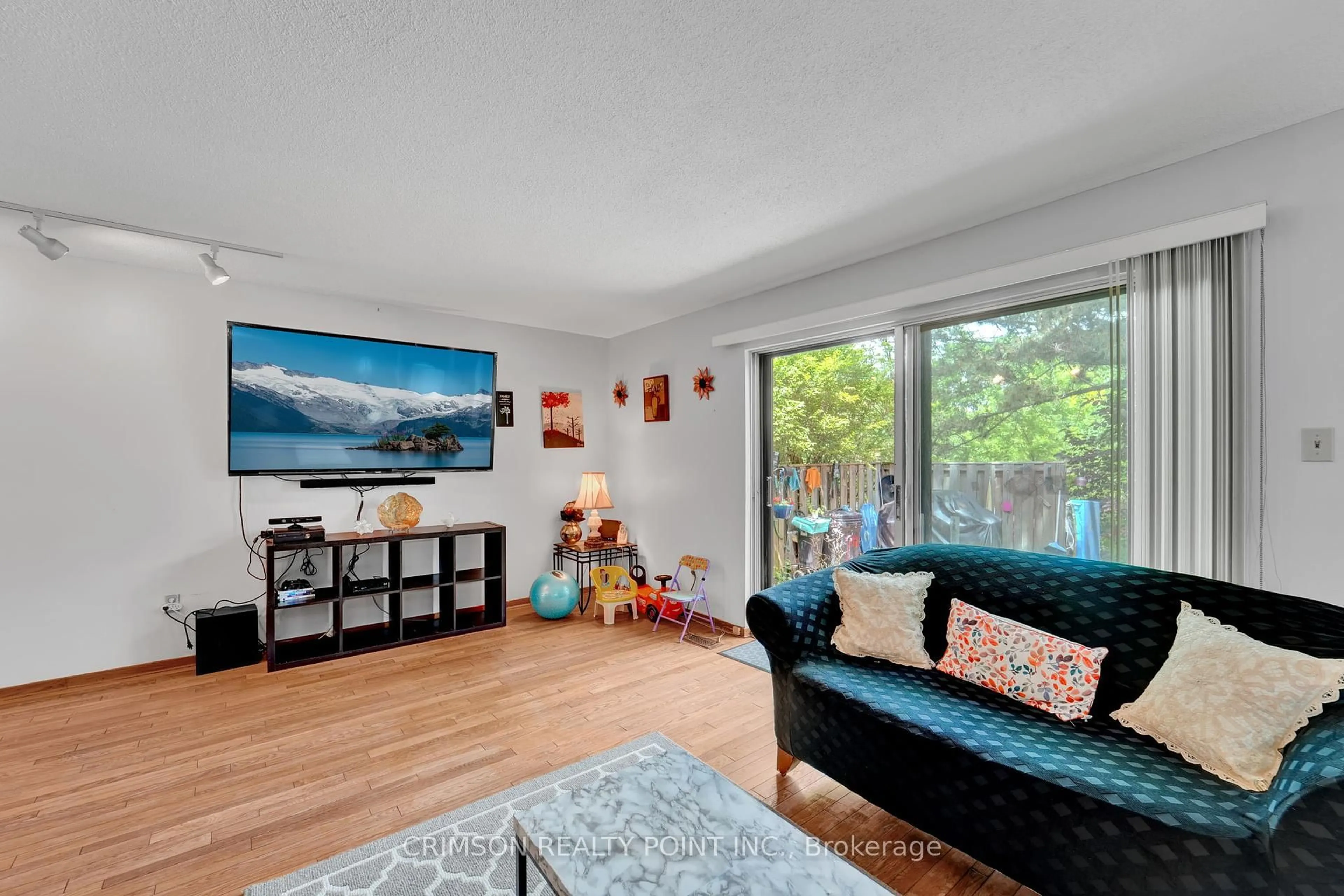 Living room with furniture, wood/laminate floor for 25 Brimwood Blvd #79, Toronto Ontario M1V 1E2