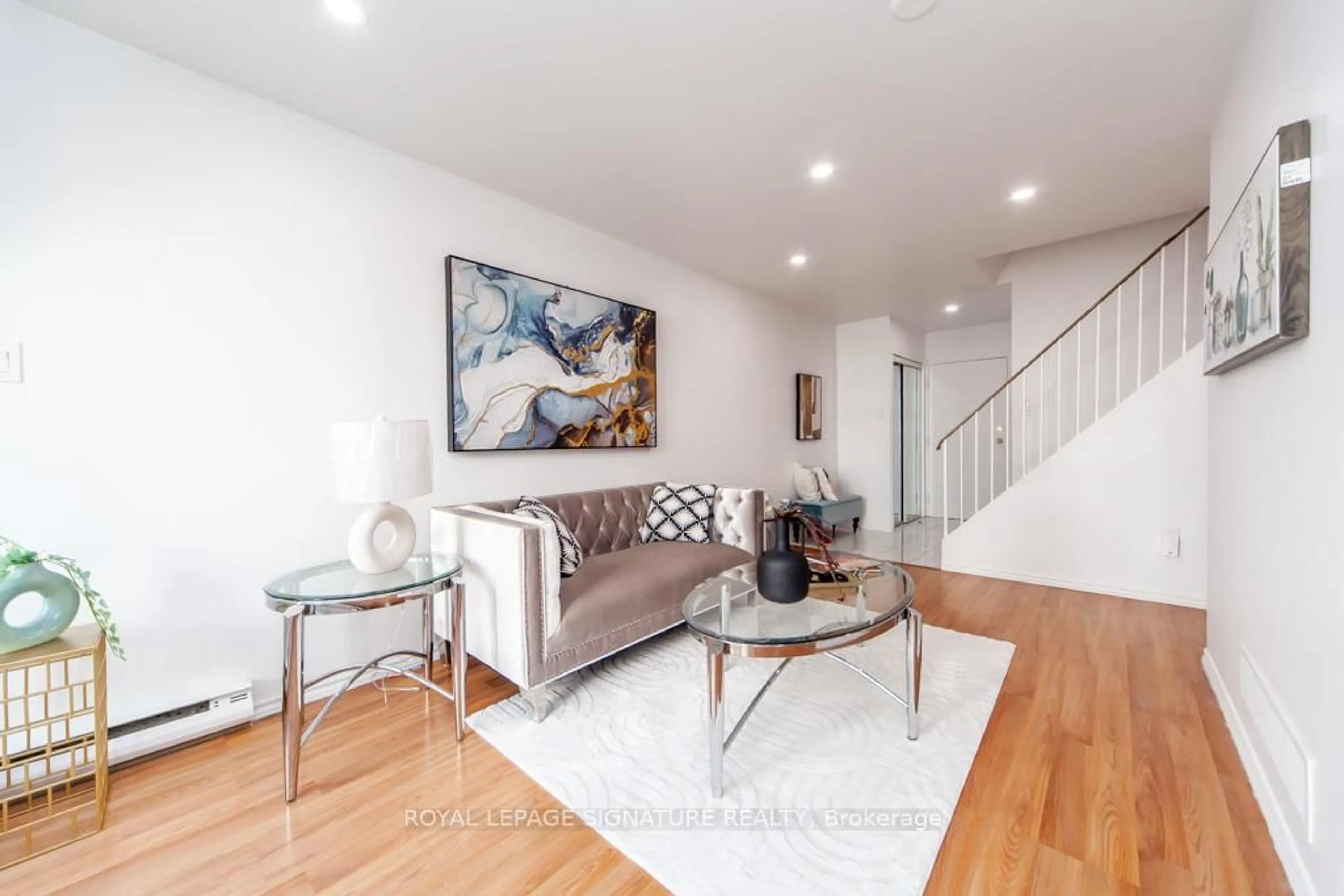 Living room with furniture, wood/laminate floor for 100 Mornelle Crt #2073, Toronto Ontario M1E 4X2