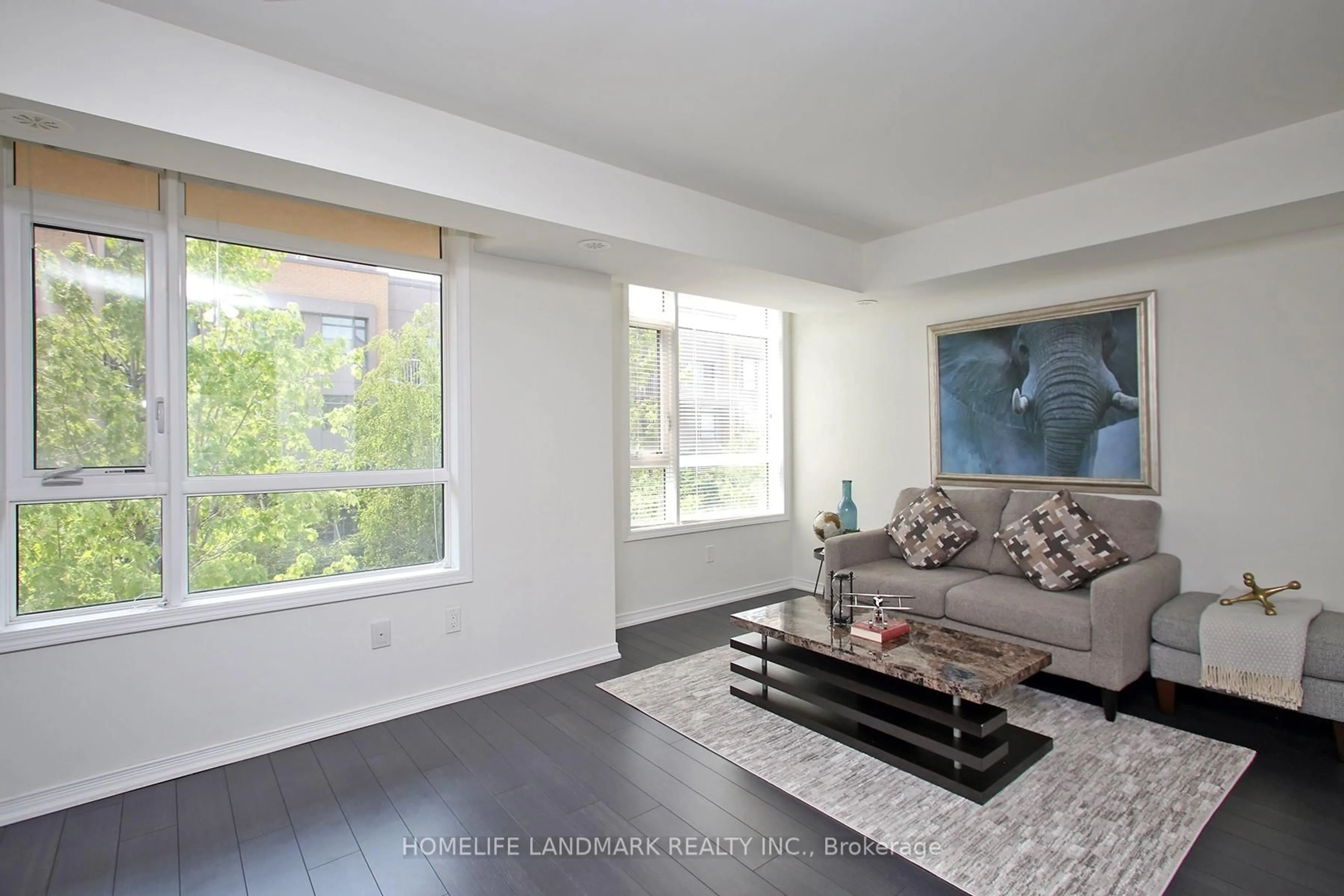 Living room with furniture, wood/laminate floor for 90 Orchid Pl #304, Toronto Ontario M1B 0C4