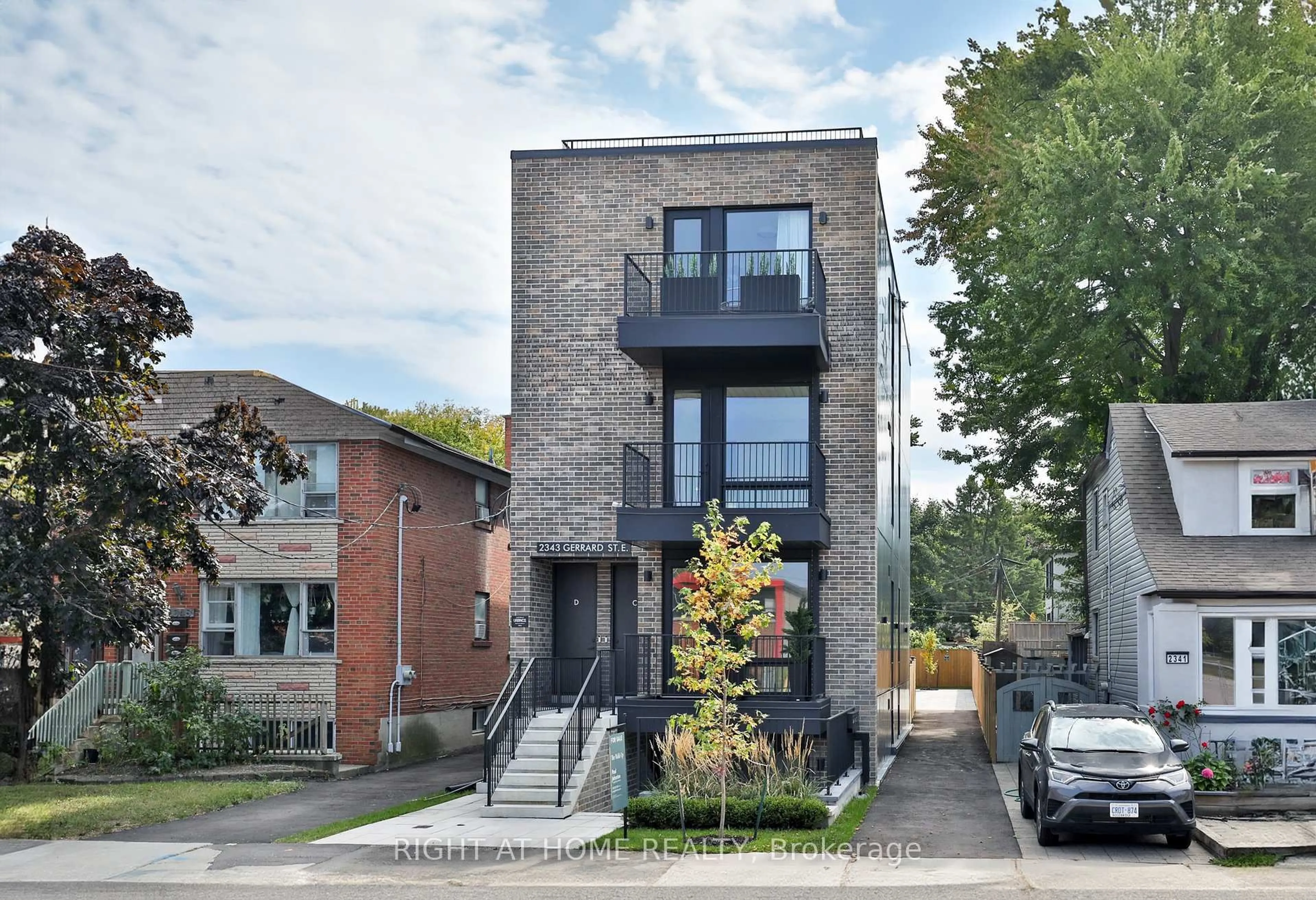 Home with brick exterior material, street for 2343 Gerrard St #Centre, Toronto Ontario M4E 2E6