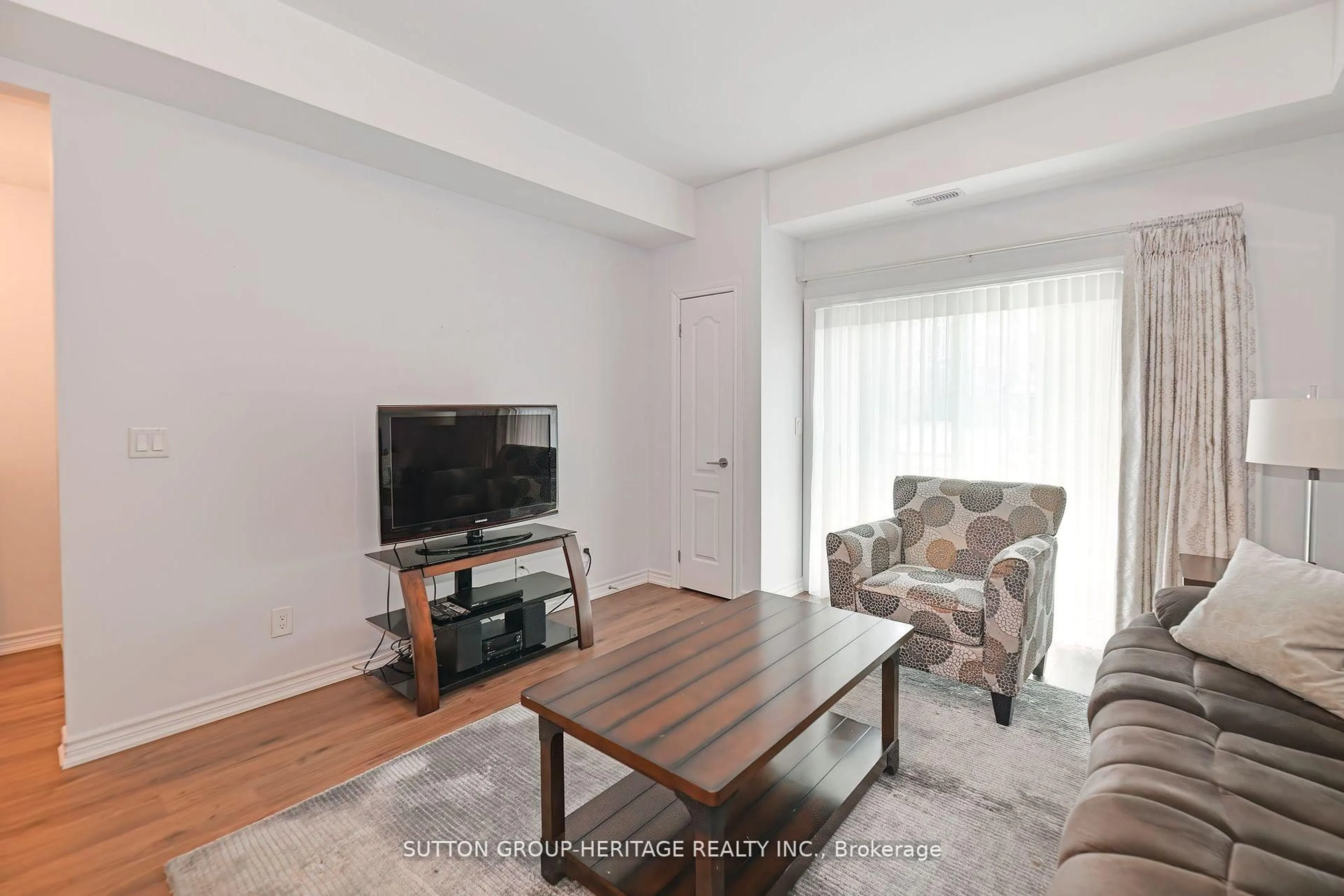Living room with furniture, wood/laminate floor for 670 Gordon St #103, Whitby Ontario L1N 5S9