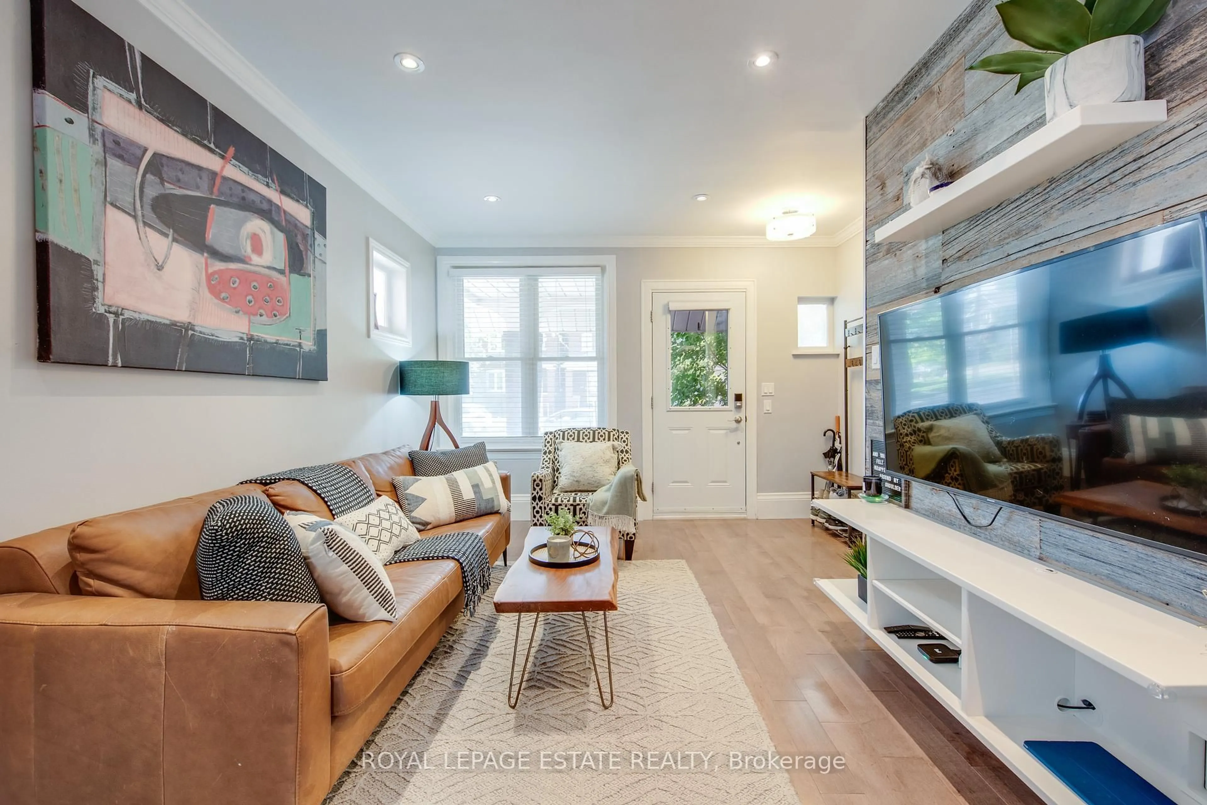 Living room with furniture, wood/laminate floor for 138 Woodmount Ave, Toronto Ontario M4C 3Y8