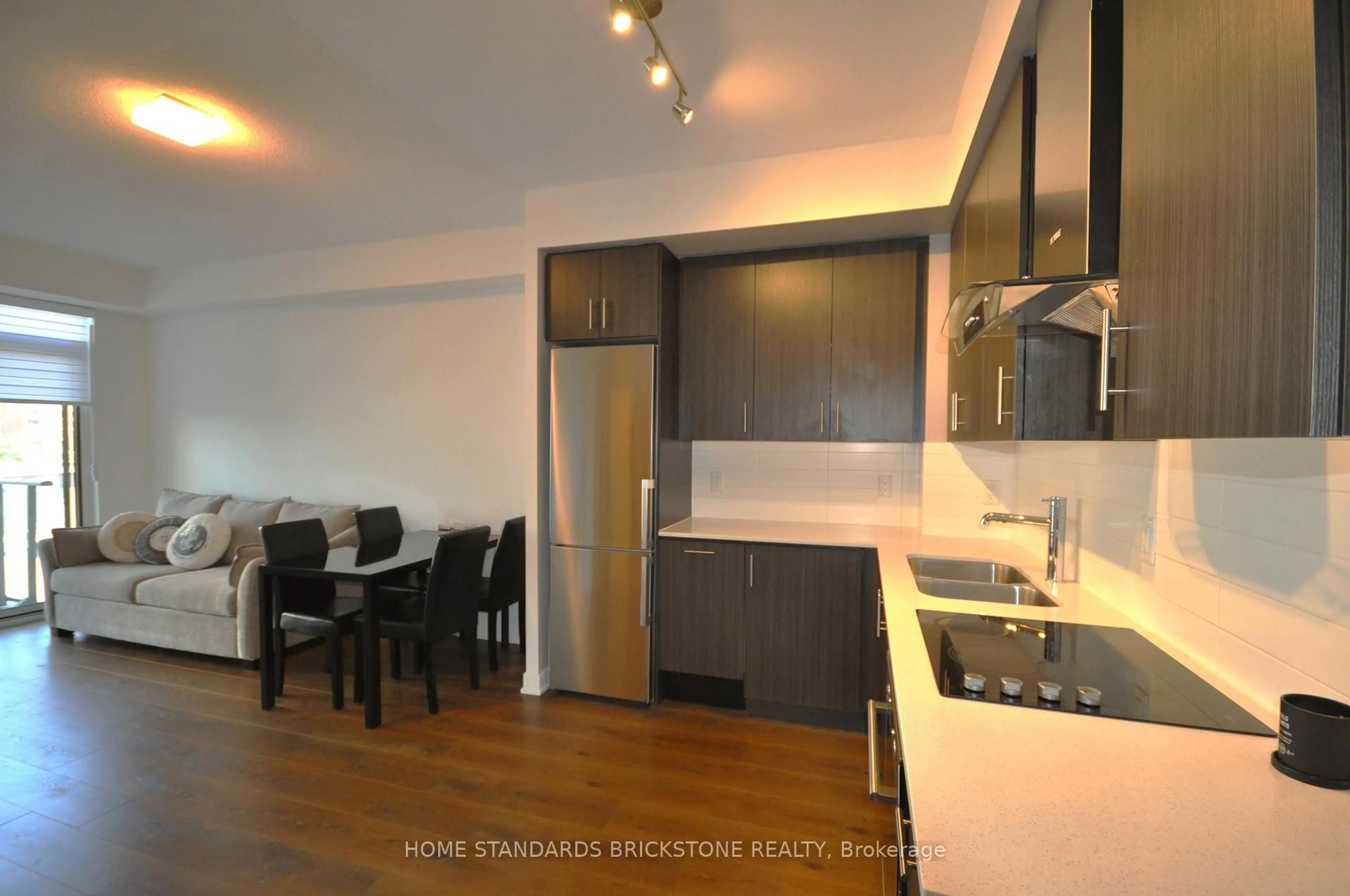 Open concept kitchen, wood/laminate floor for 195 Bonis Ave #406, Toronto Ontario M1T 0A5