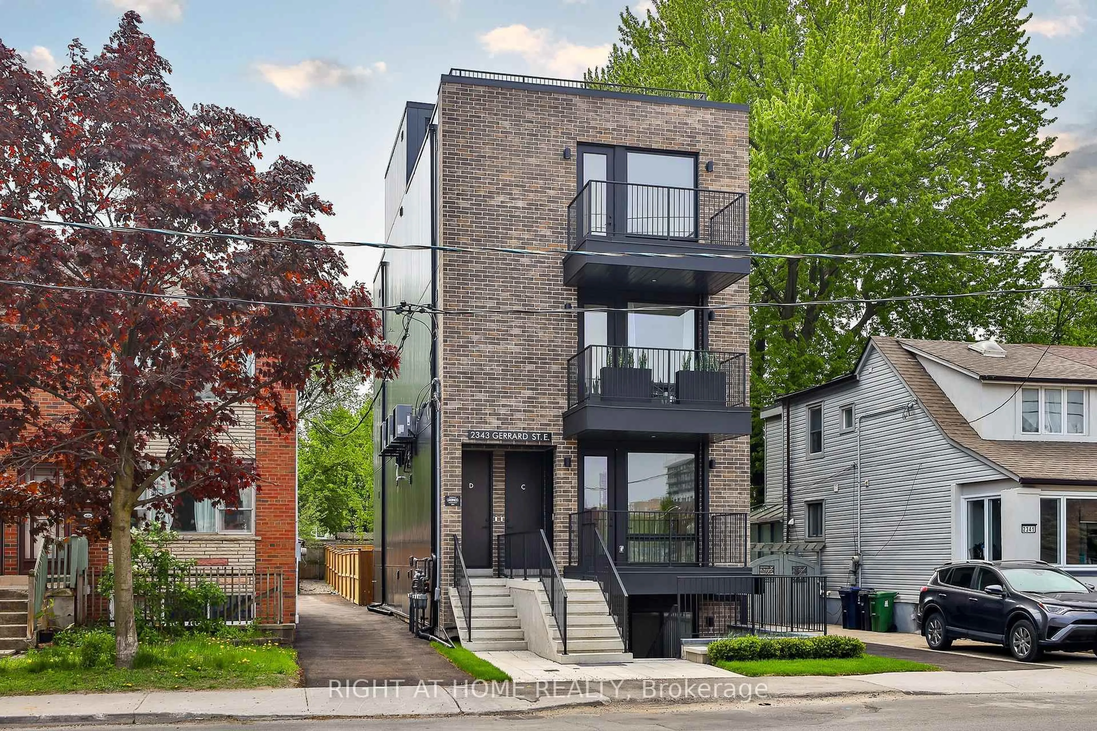 Home with brick exterior material, street for 2343 Gerrard St, Toronto Ontario M4E 2E6