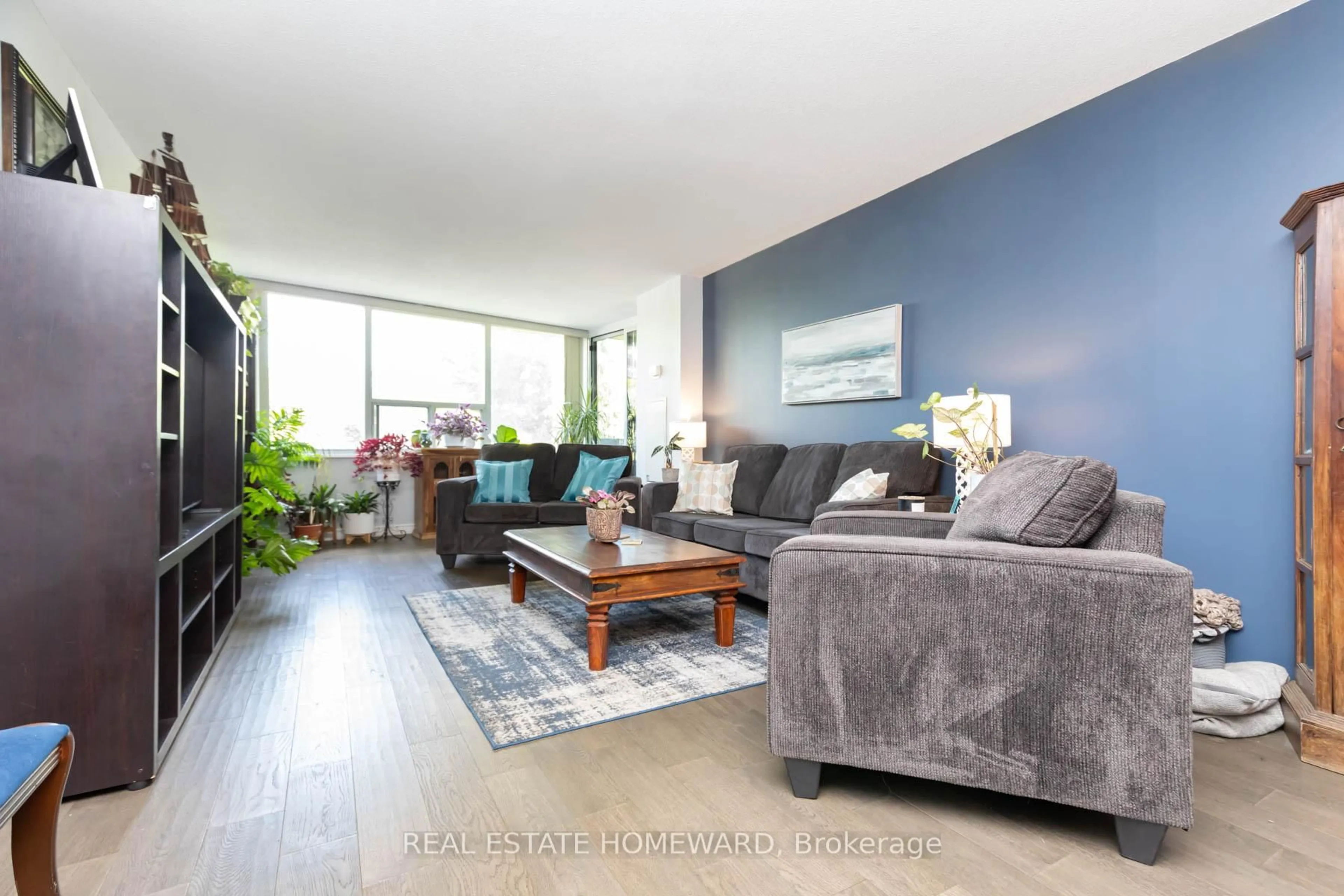 Living room with furniture, wood/laminate floor for 45 Huntingdale Blvd #106, Toronto Ontario M1W 2N8