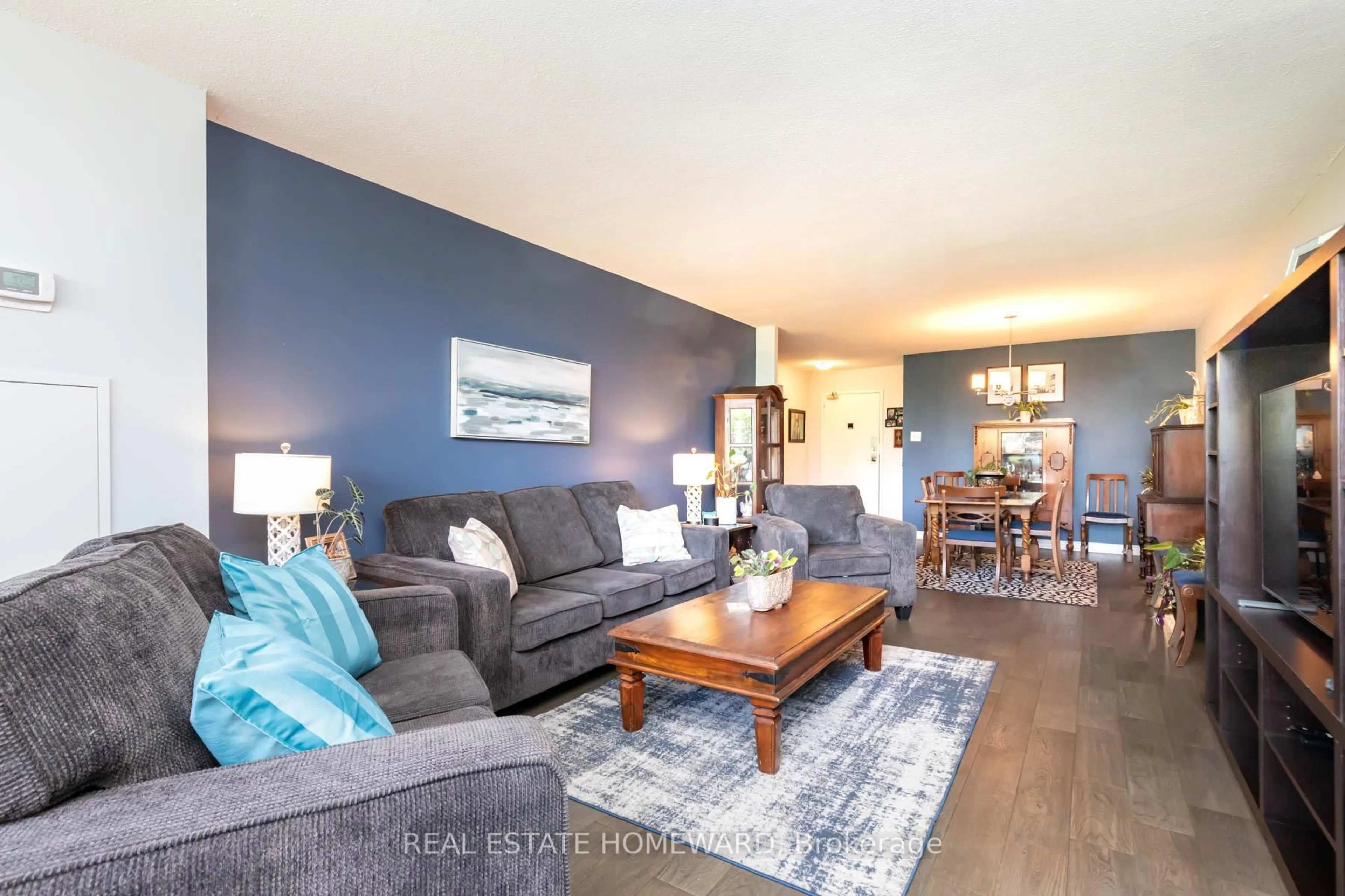 Living room with furniture, wood/laminate floor for 45 Huntingdale Blvd #106, Toronto Ontario M1W 2N8