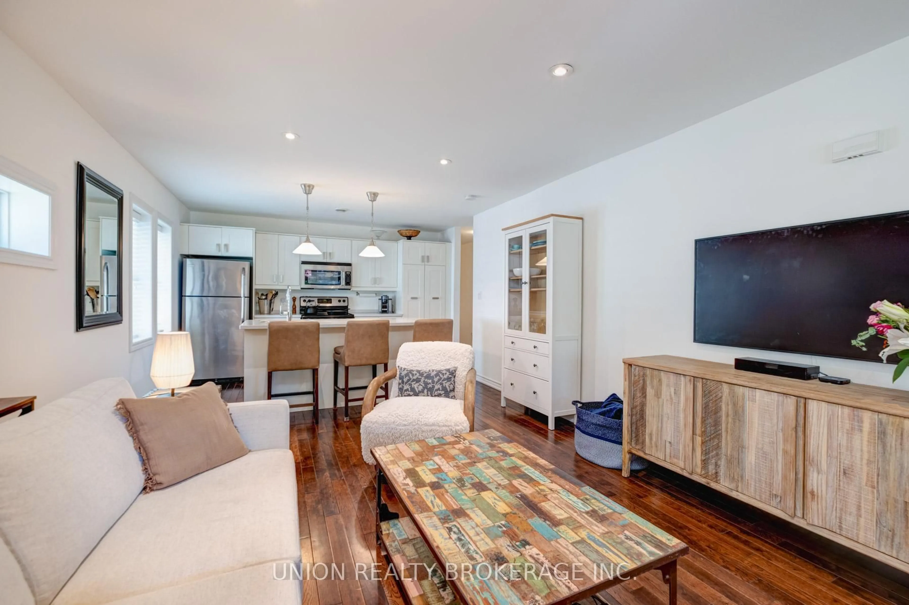 Living room with furniture, wood/laminate floor for 11 Bonfield Ave, Toronto Ontario M4E 1B9