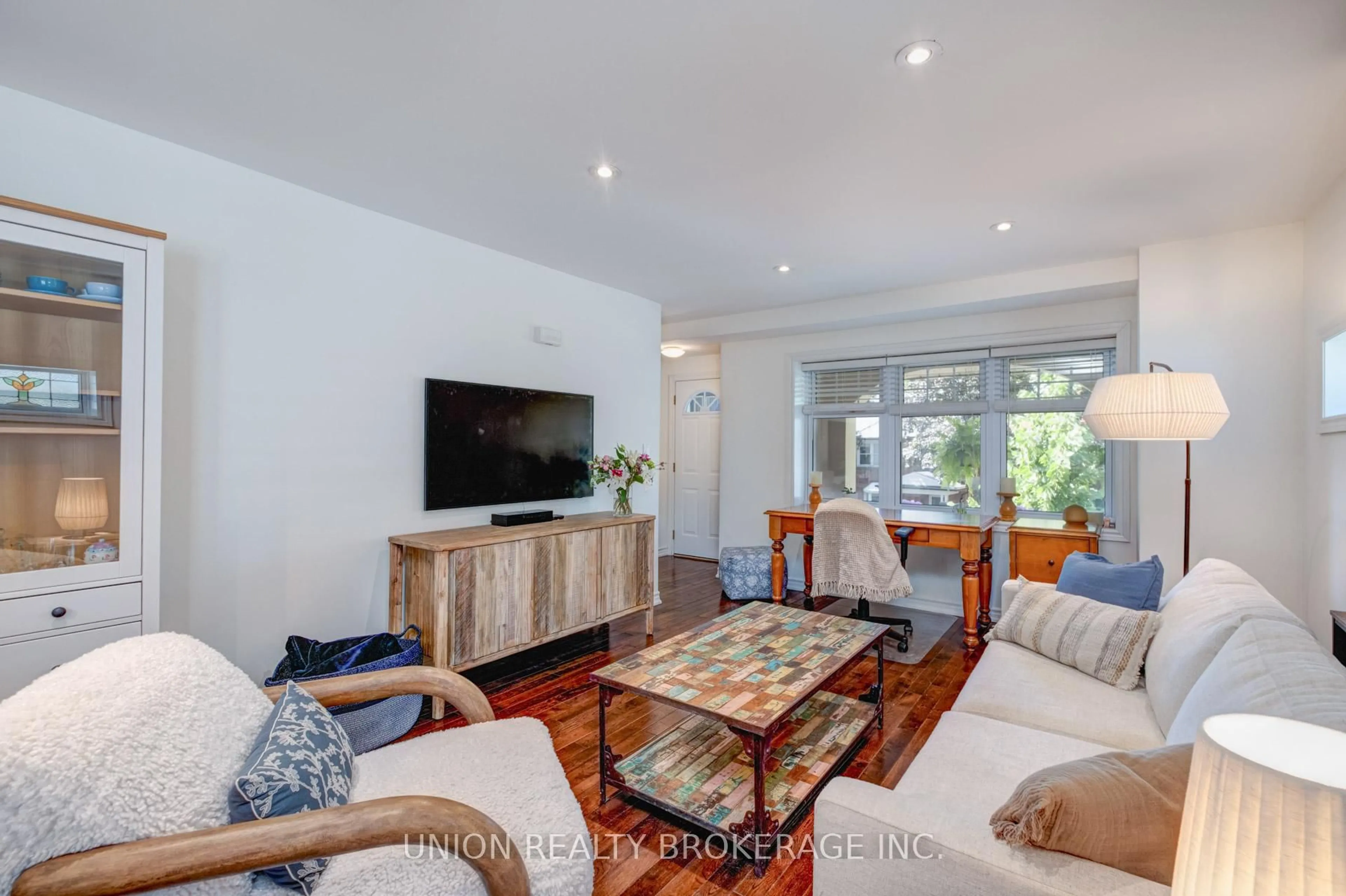 Living room with furniture, wood/laminate floor for 11 Bonfield Ave, Toronto Ontario M4E 1B9