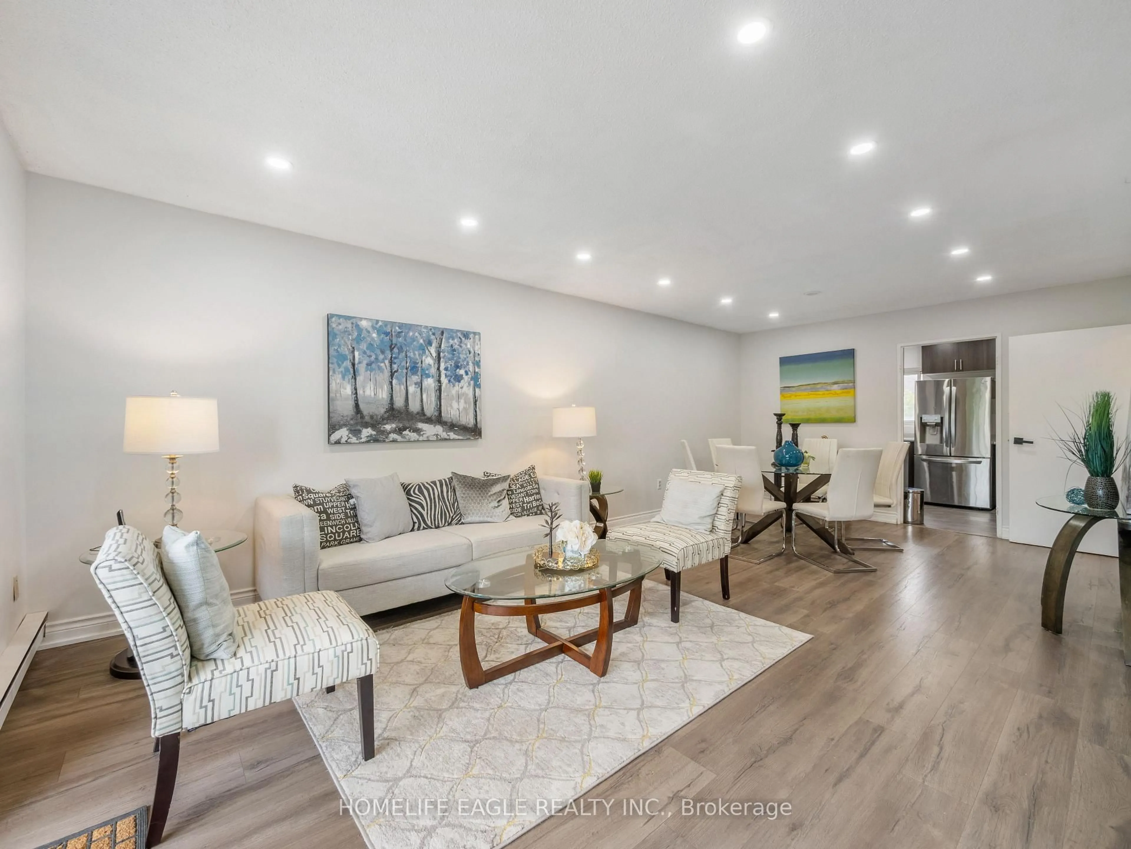 Living room with furniture, wood/laminate floor for 50 Golf Club Rd #118, Toronto Ontario M1M 3T5