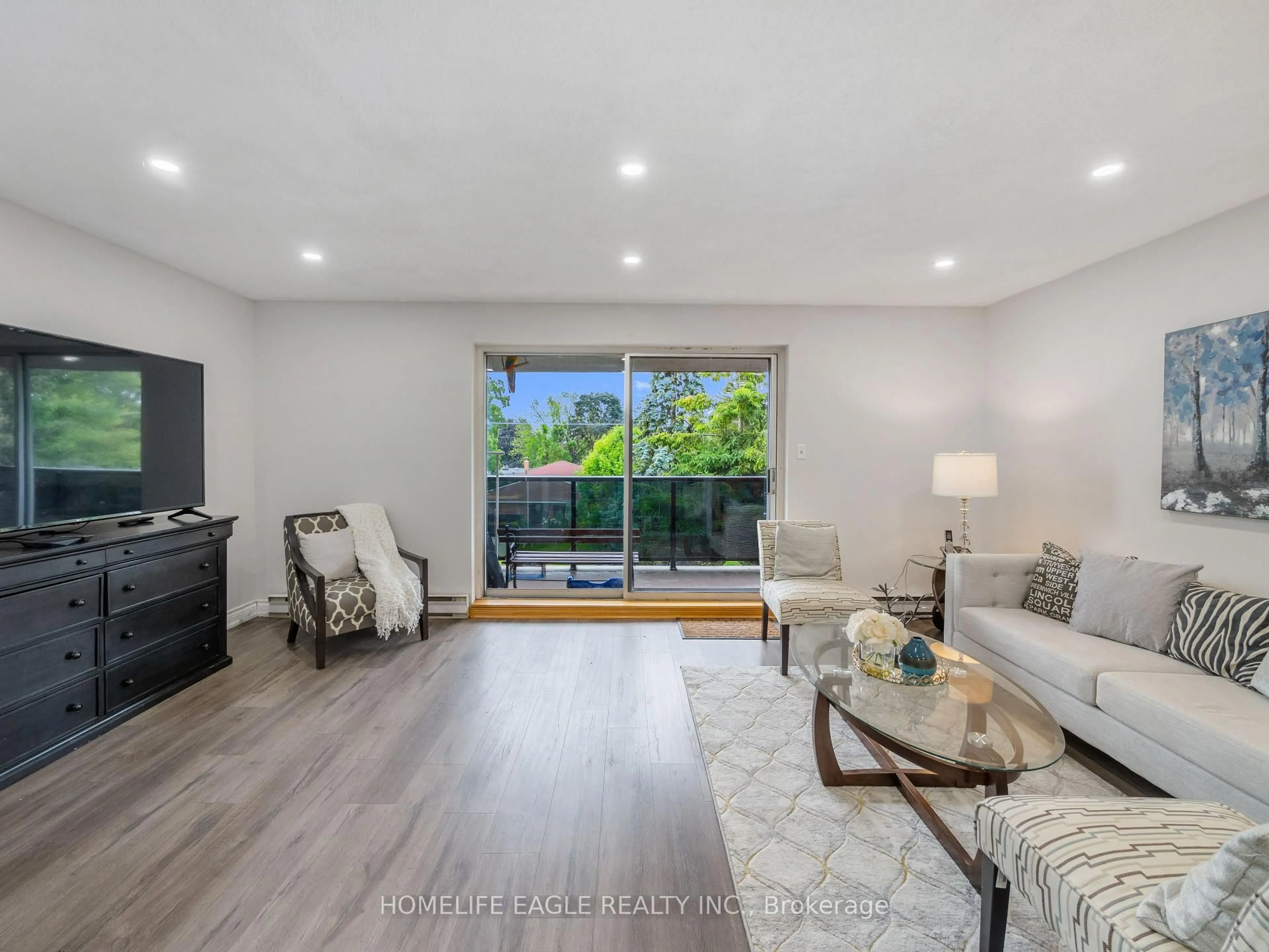 Living room with furniture, wood/laminate floor for 50 Golf Club Rd #118, Toronto Ontario M1M 3T5