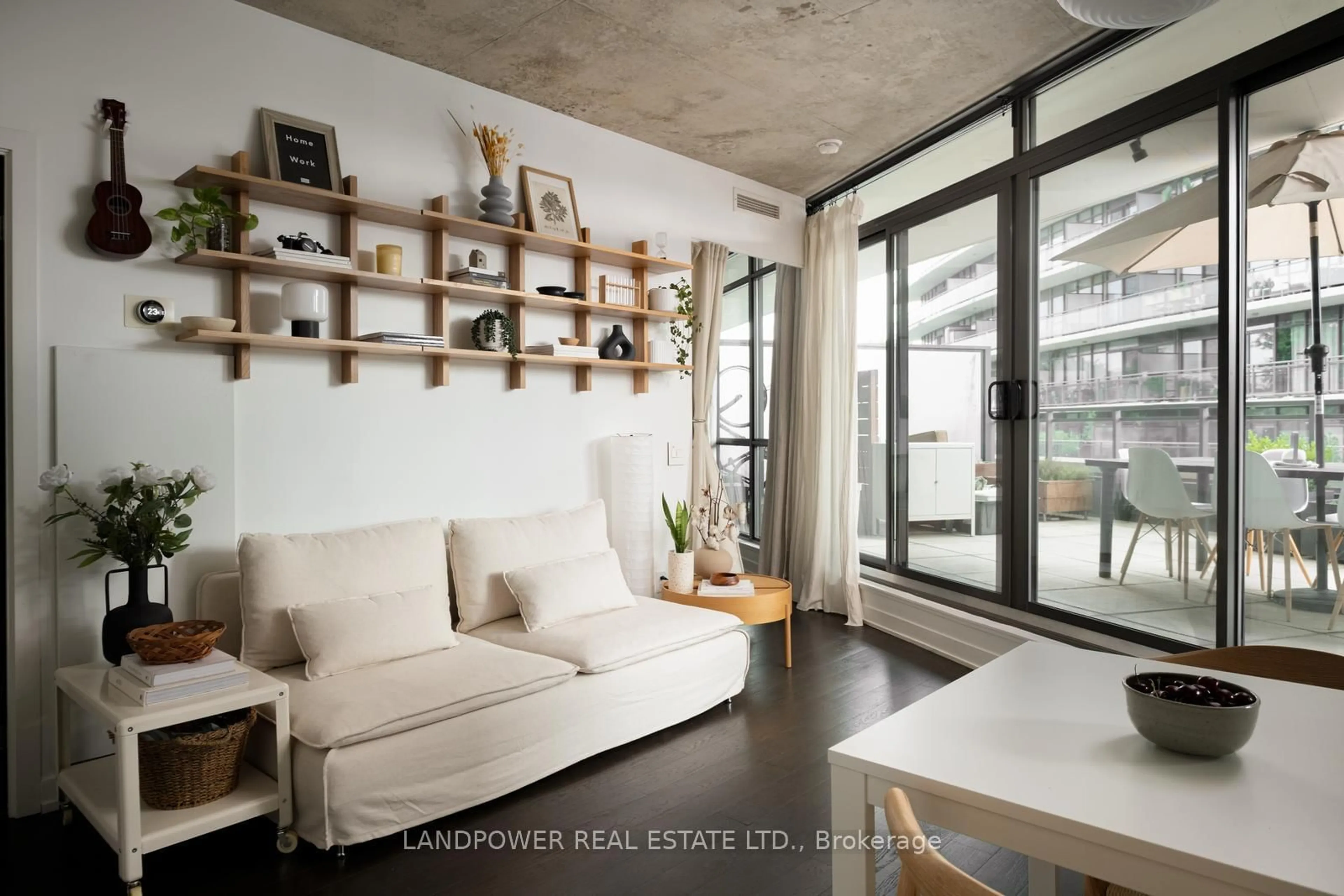 Living room with furniture, cement floor for 1201 Dundas St #302, Toronto Ontario M4M 1S2