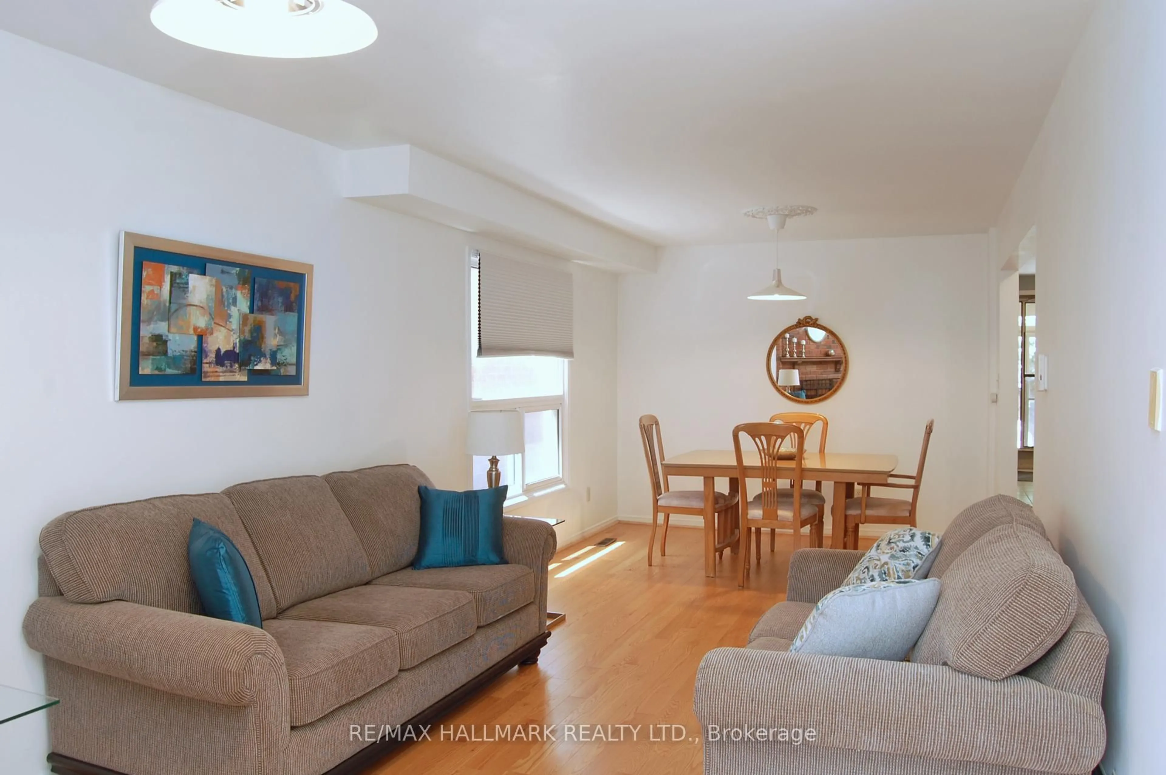 Living room with furniture, wood/laminate floor for 113 Mammoth Hall Tr, Toronto Ontario M1B 1P8