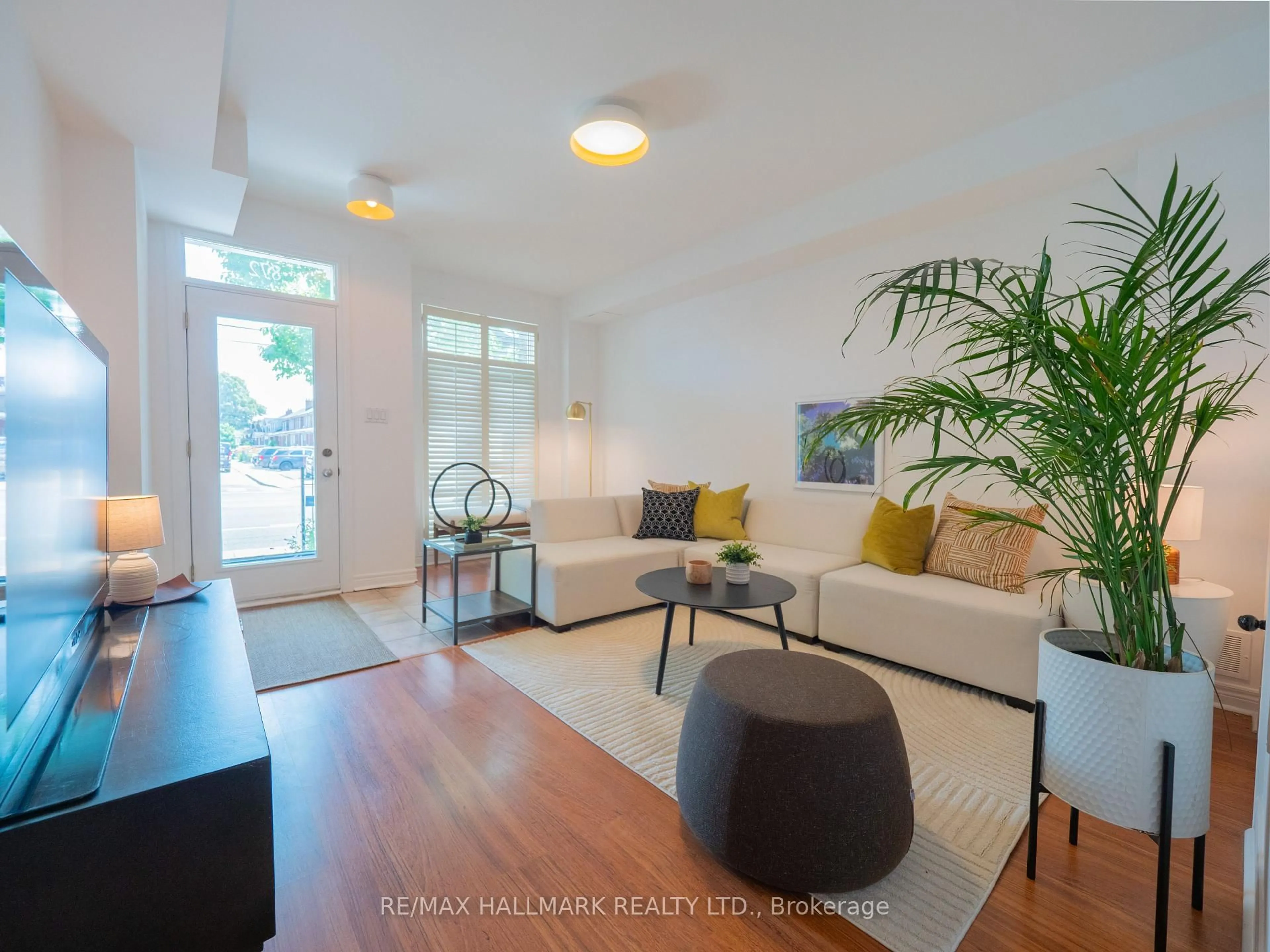 Living room with furniture, wood/laminate floor for 872 Pape Ave, Toronto Ontario M4K 3T8