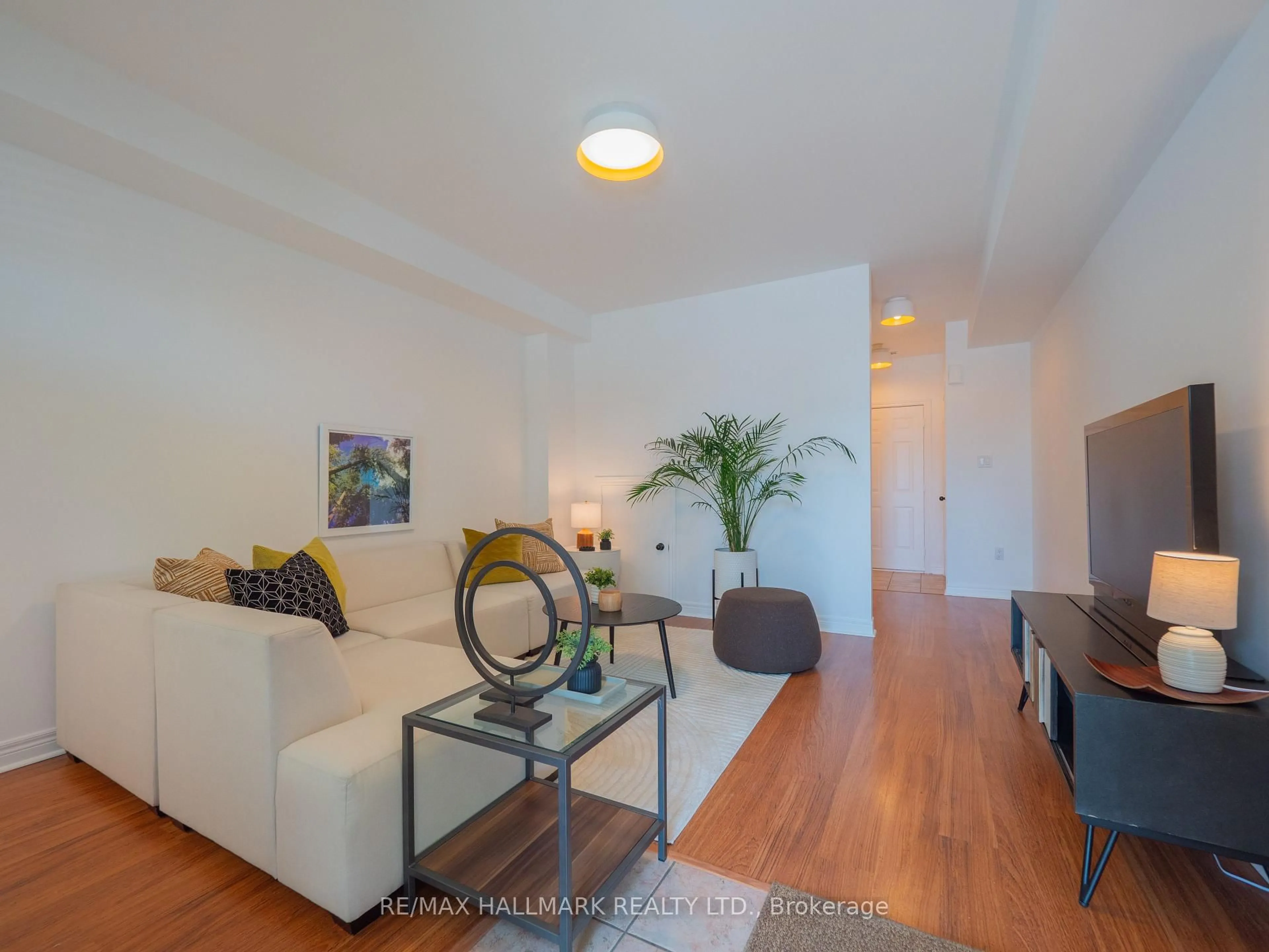 Living room with furniture, wood/laminate floor for 872 Pape Ave, Toronto Ontario M4K 3T8
