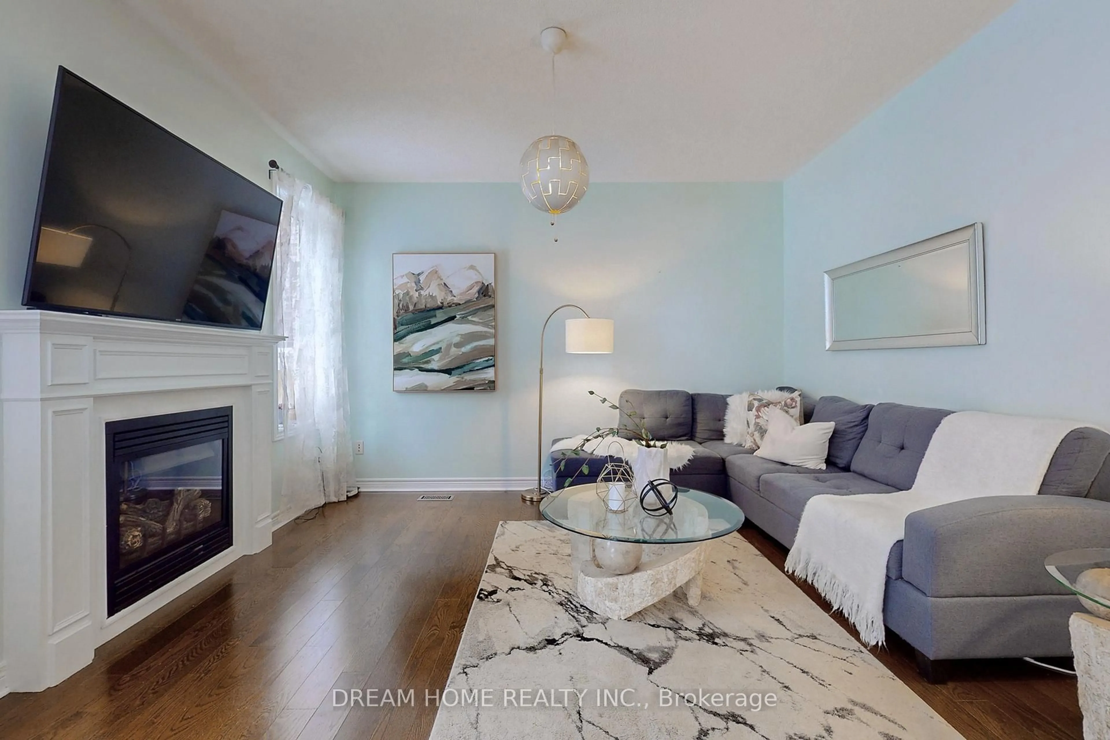 Living room with furniture, wood/laminate floor for 63 Murray Tabb St, Clarington Ontario L1C 0P8