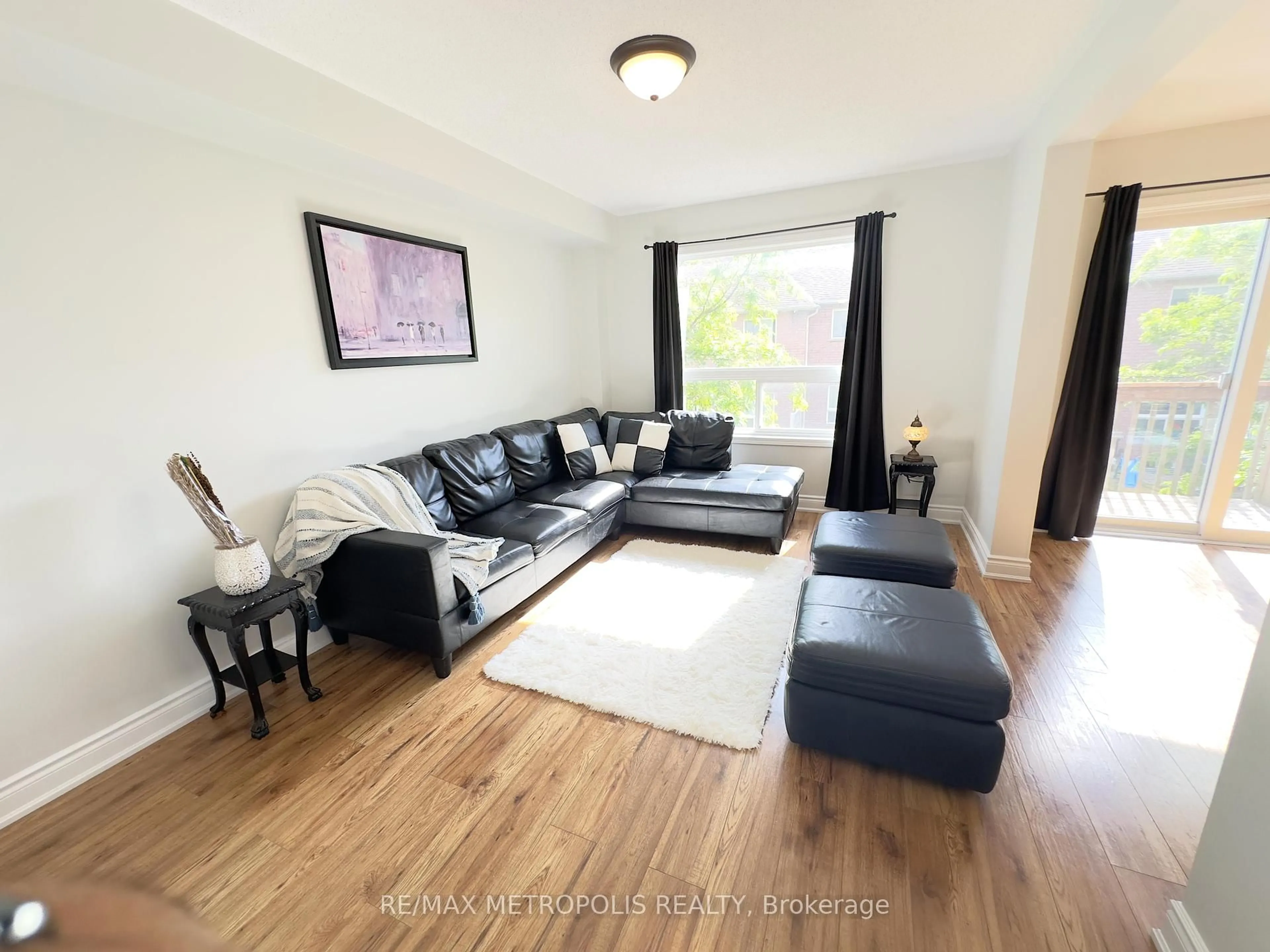 Living room with furniture, wood/laminate floor for 1087 Ormond Dr #48, Oshawa Ontario L1K 0E8