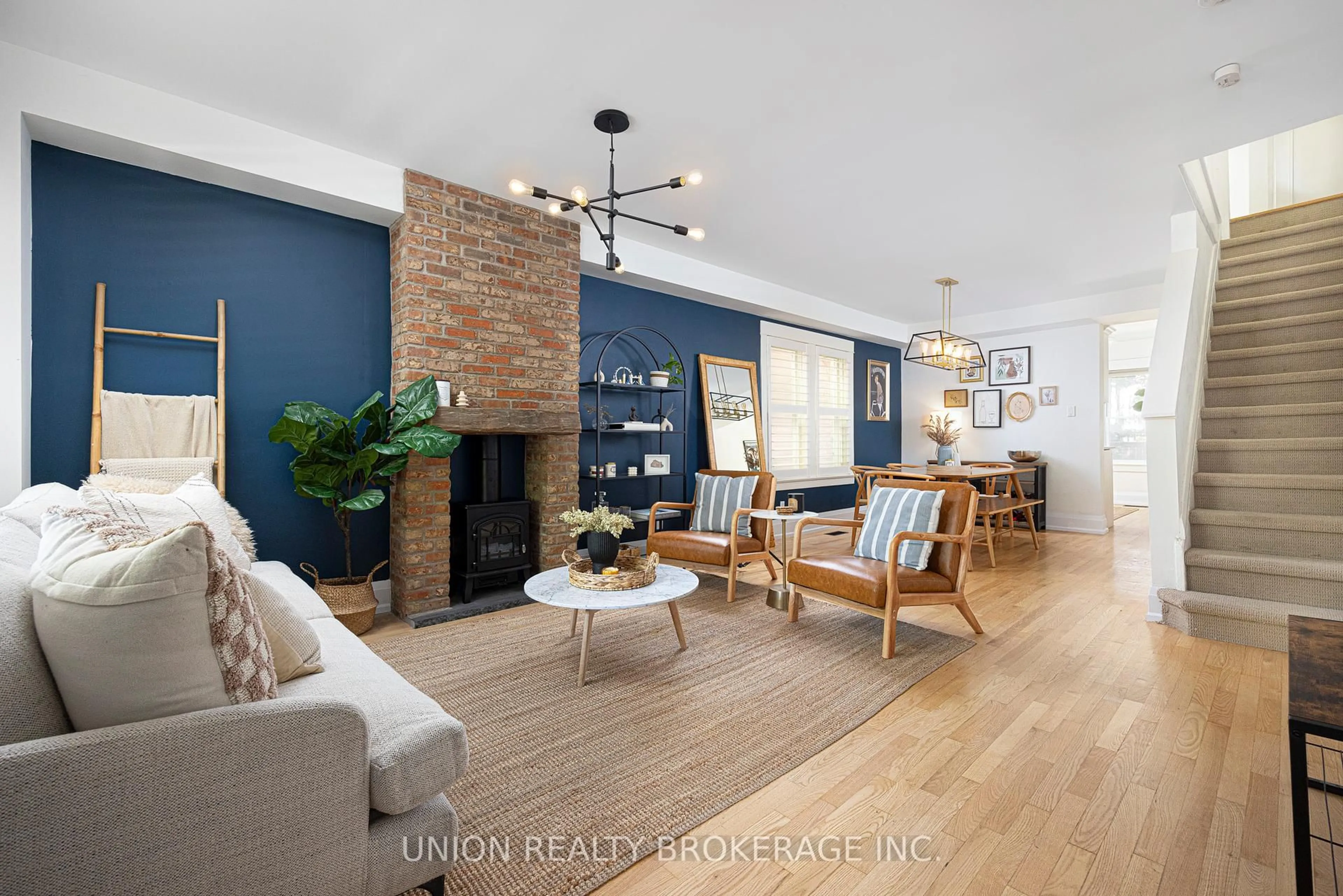 Living room with furniture, wood/laminate floor for 152 Milverton Blvd, Toronto Ontario M4J 1V3