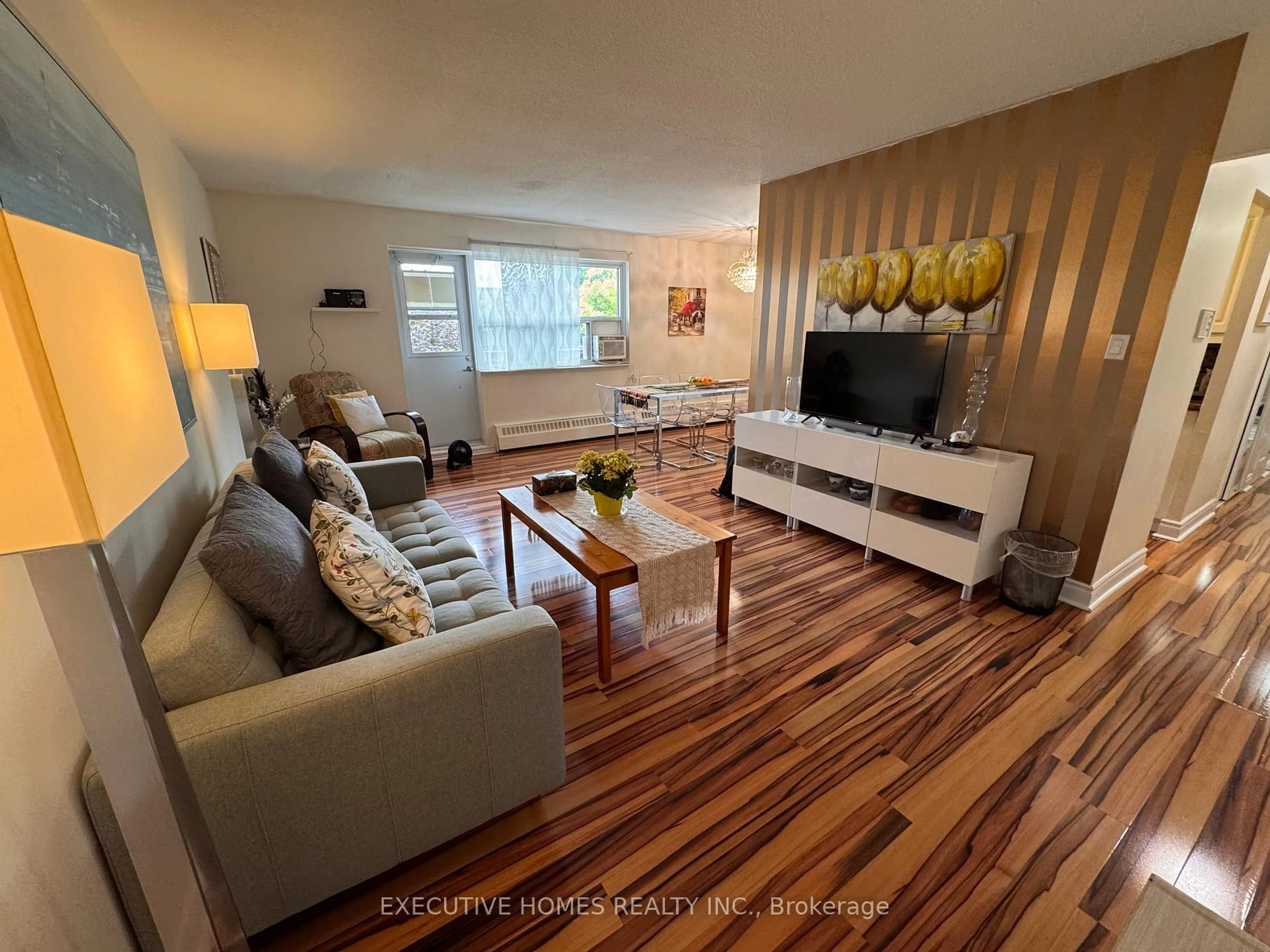 Living room with furniture, wood/laminate floor for 900 Glen St #414, Oshawa Ontario L1J 5Z5