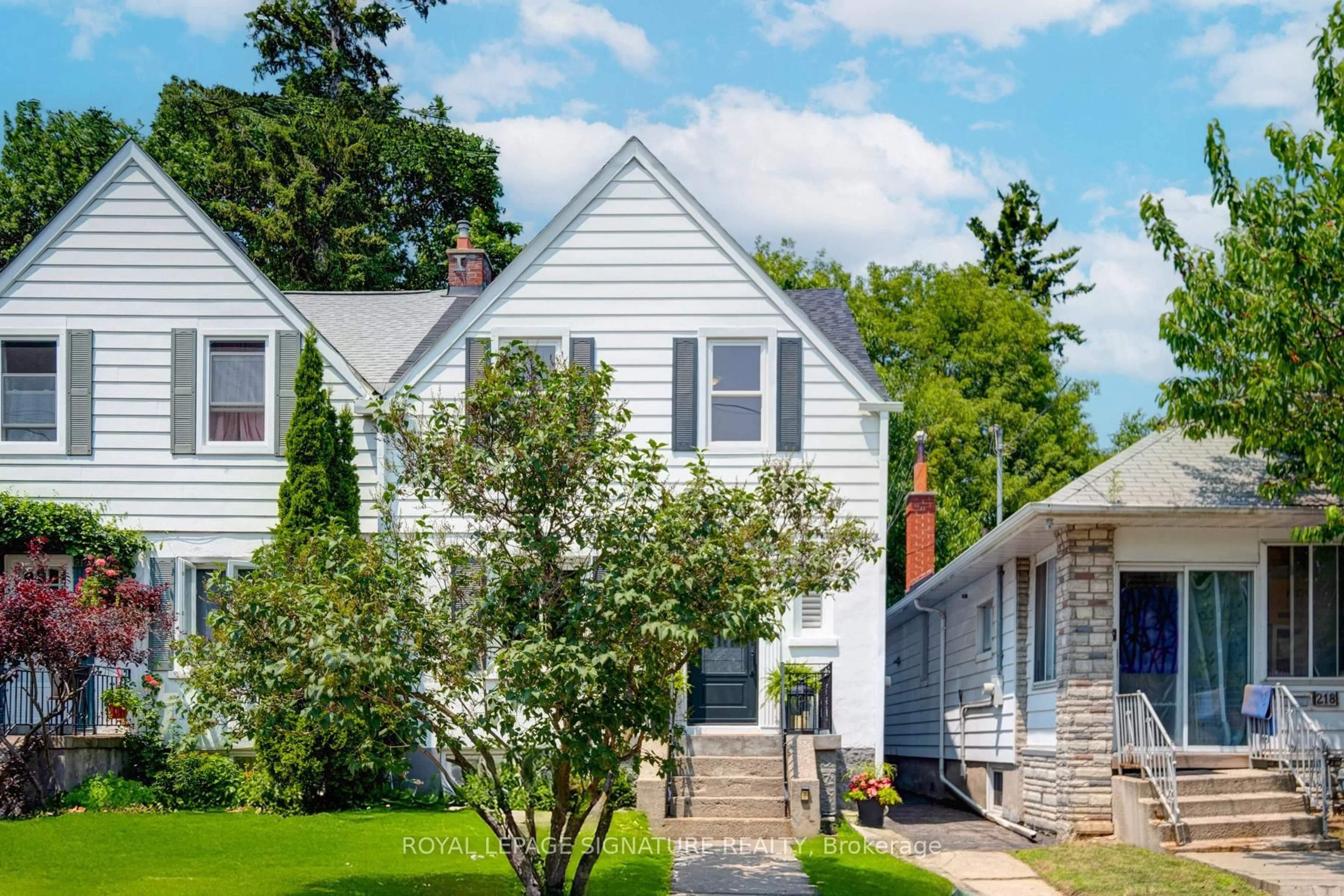 Home with vinyl exterior material, street for 216 Holborne Ave, Toronto Ontario M4C 2R9