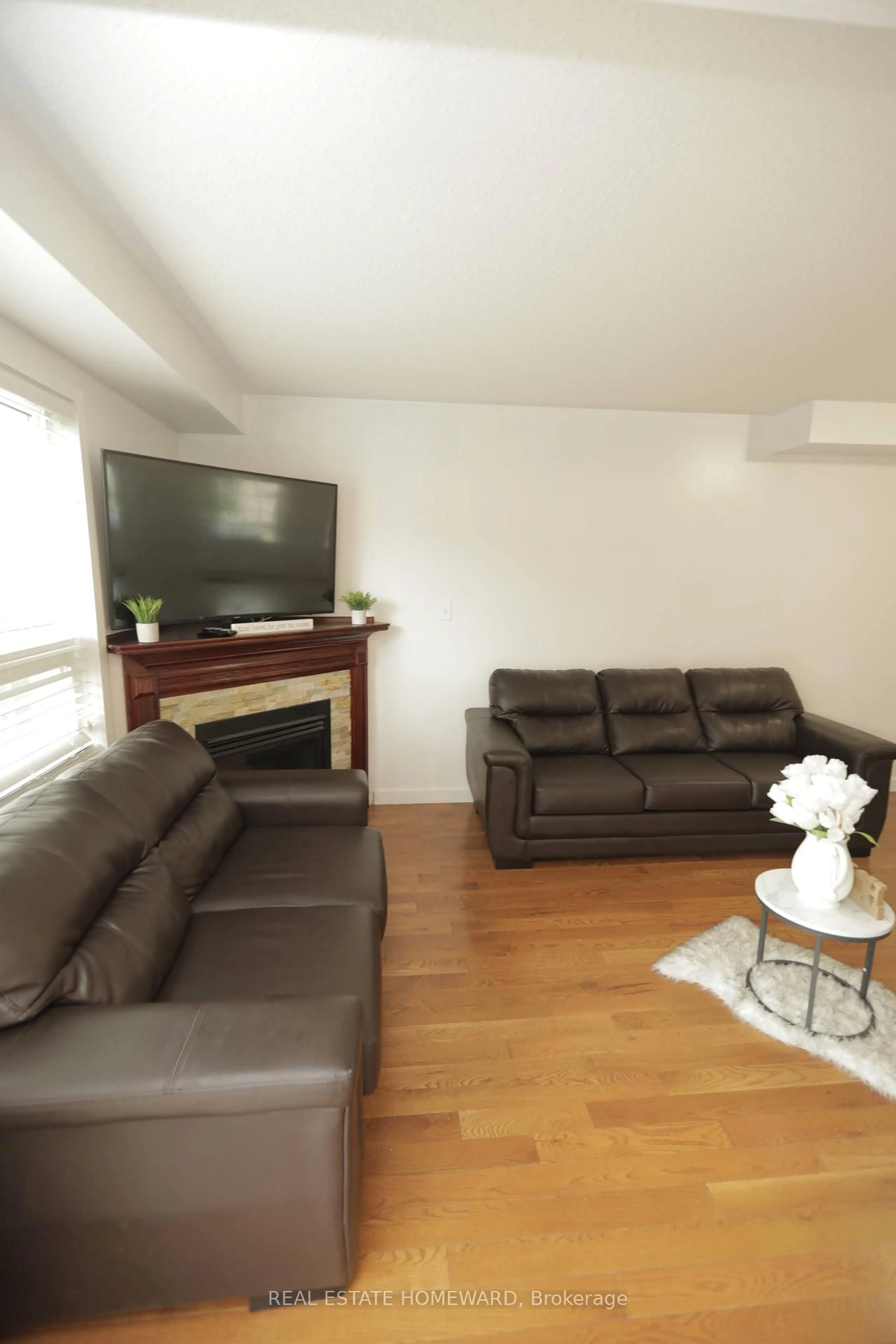 Living room with furniture, wood/laminate floor for 560 Falconridge Dr, Oshawa Ontario L1K 0C1