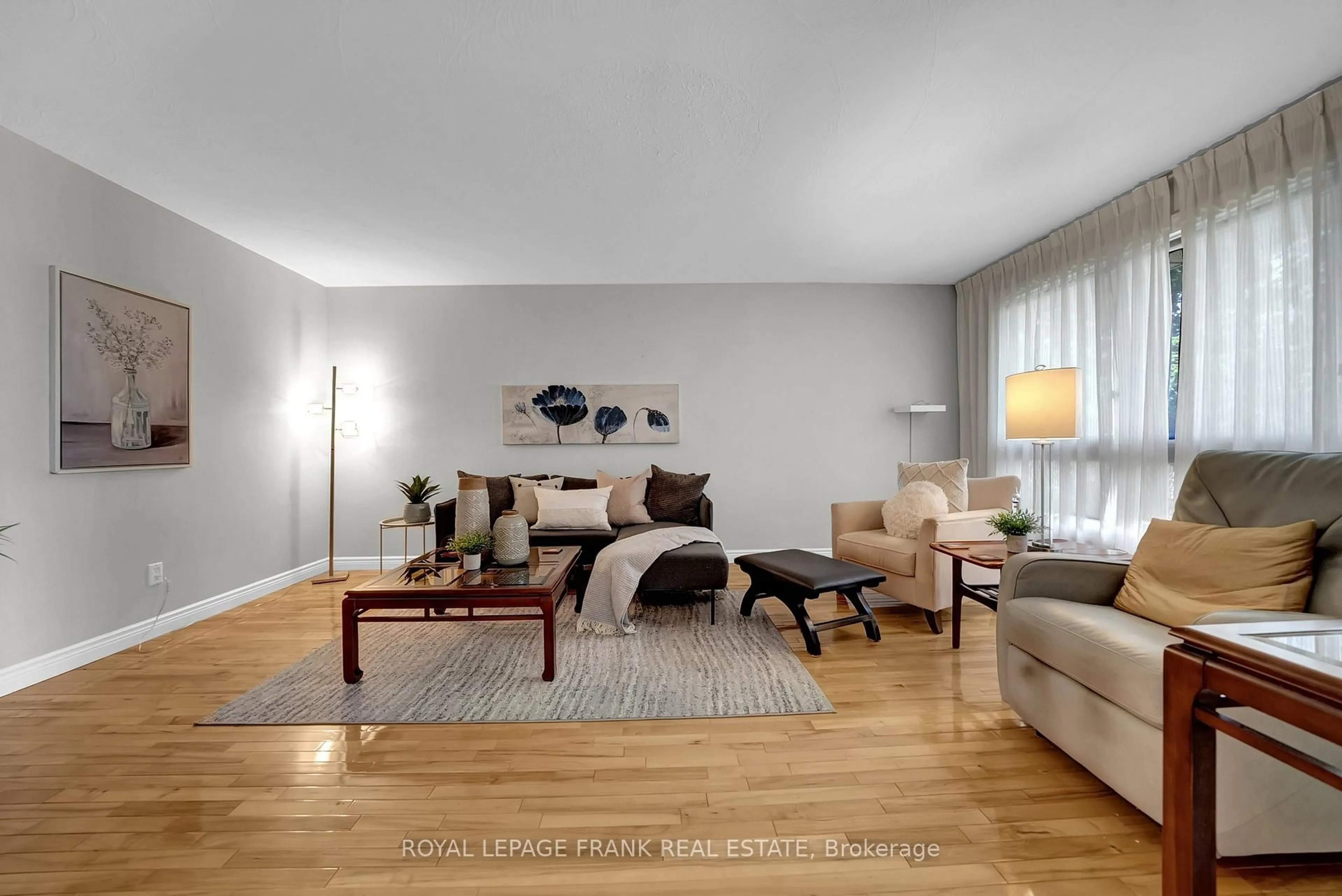 Living room with furniture, wood/laminate floor for 406 Wilson Rd, Oshawa Ontario L1G 6E5