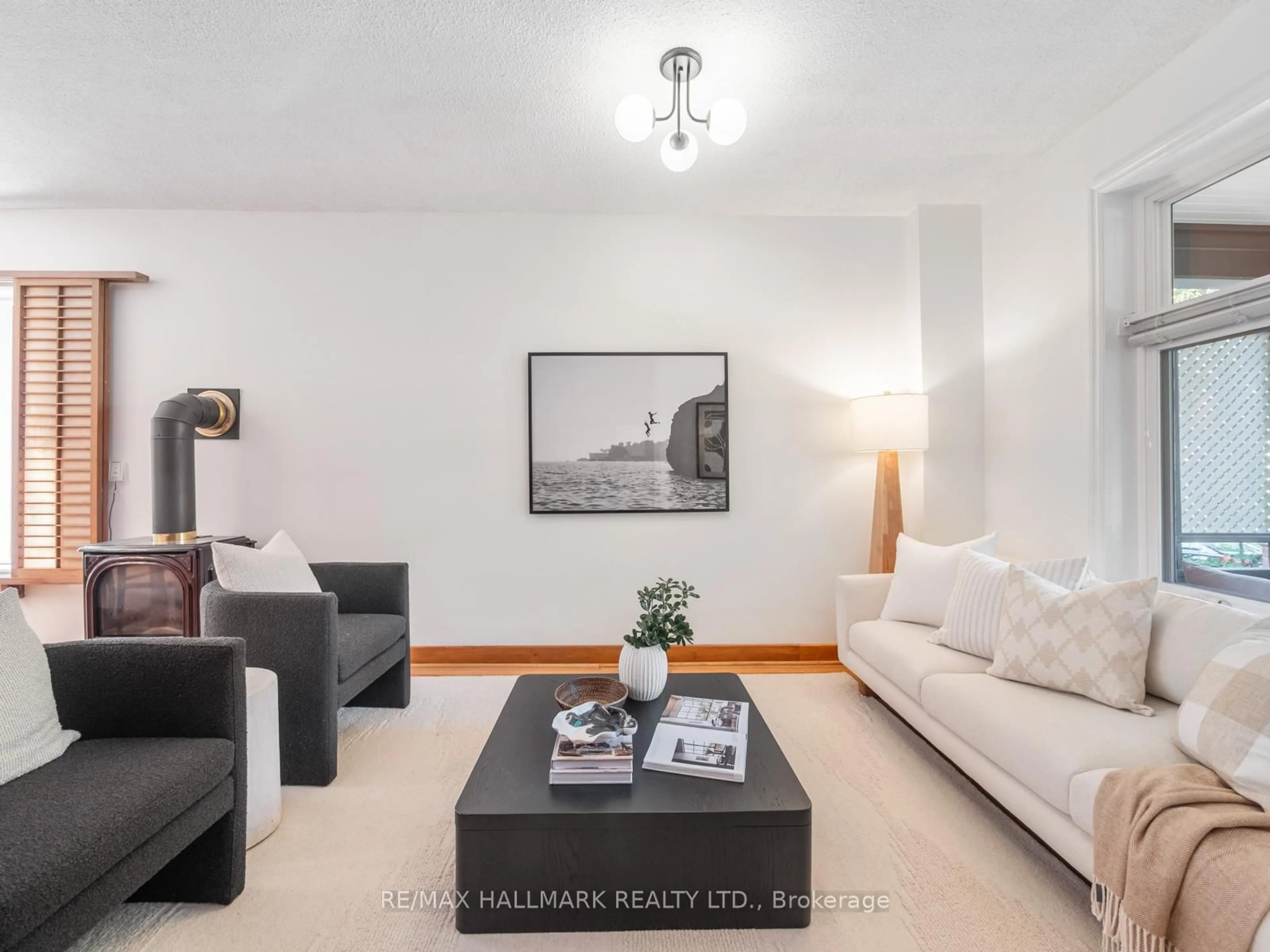 Living room with furniture, wood/laminate floor for 81 Woodycrest Ave, Toronto Ontario M4J 3A8