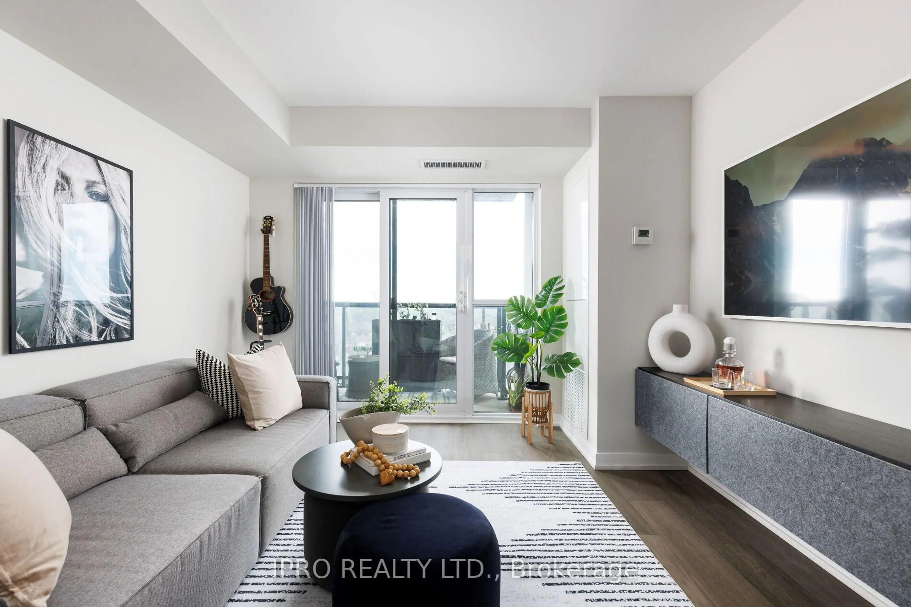 Living room with furniture, wood/laminate floor for 8 Trent Ave #807, Toronto Ontario M4C 0A6