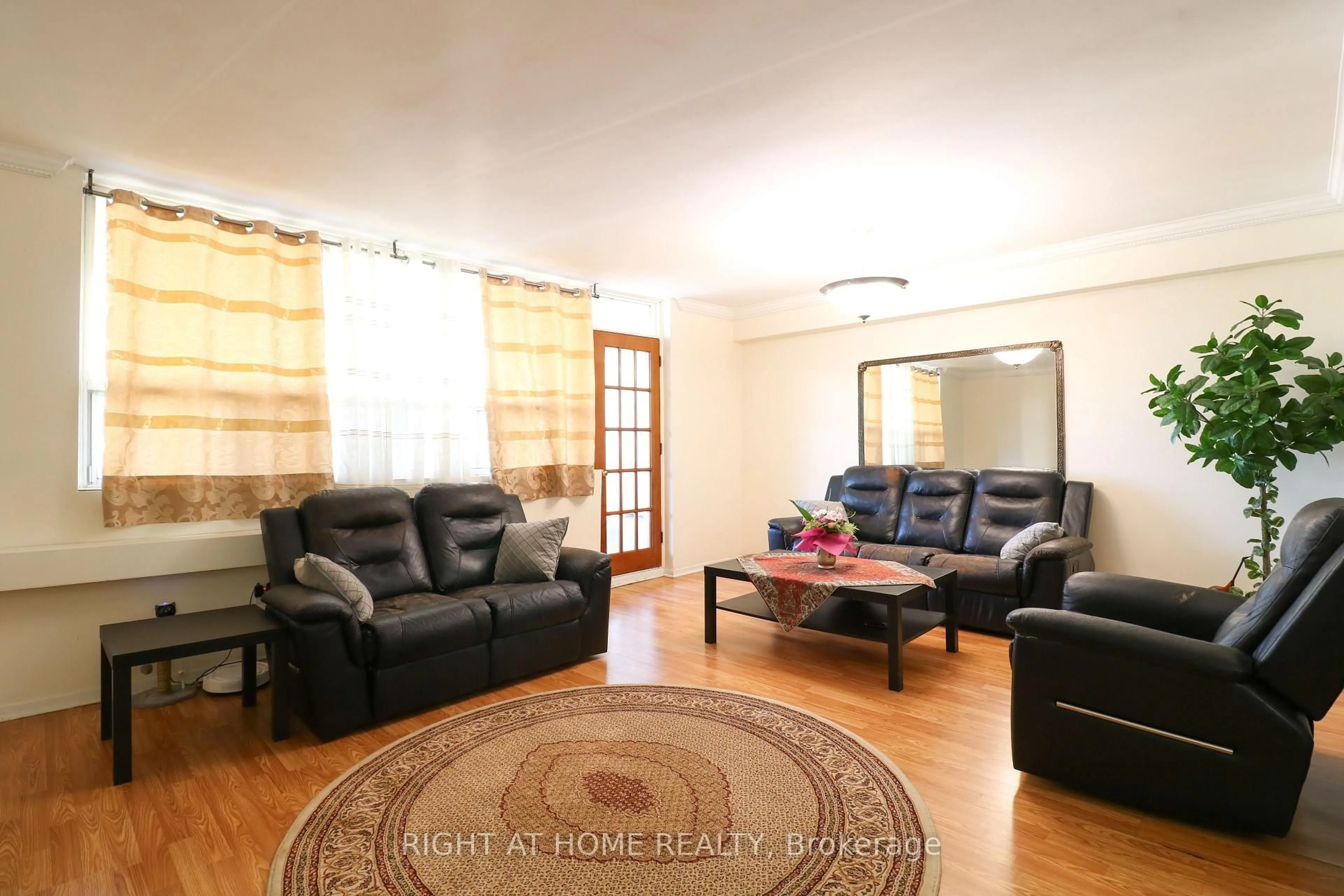 Living room with furniture, wood/laminate floor for 3420 Eglinton Ave #407, Toronto Ontario M1J 2H9