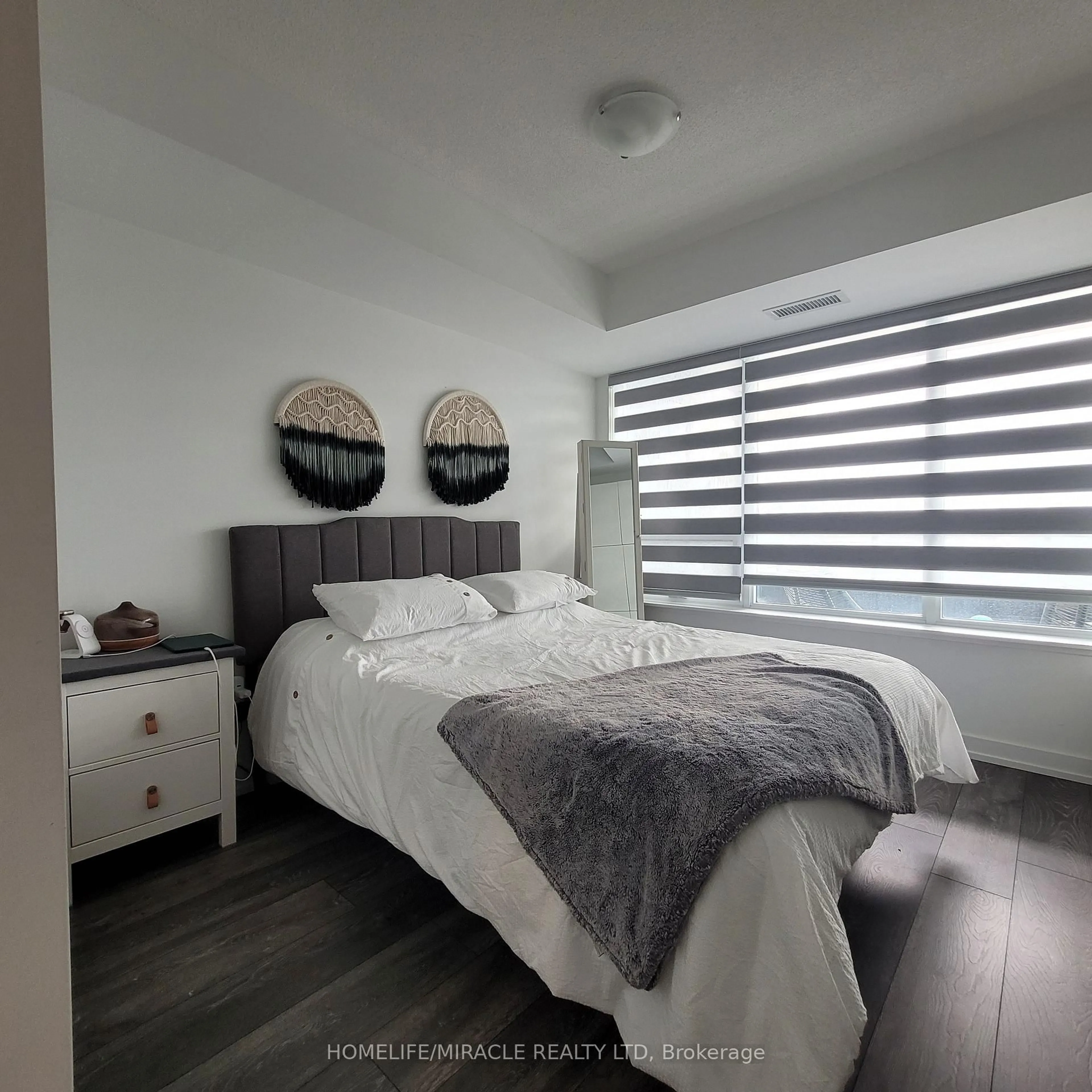 Bedroom with bed, wood/laminate floor for 1455 Celebration Dr #302, Pickering Ontario L1W 1L8