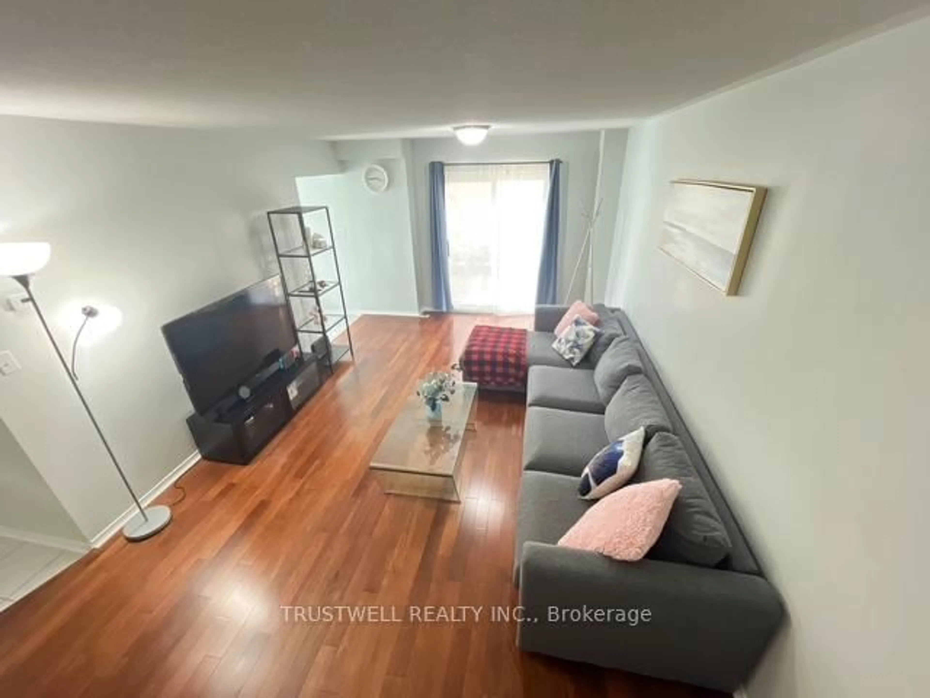 Living room with furniture, wood/laminate floor for 28 Rosebank Dr #1502, Toronto Ontario M1B 5Z1