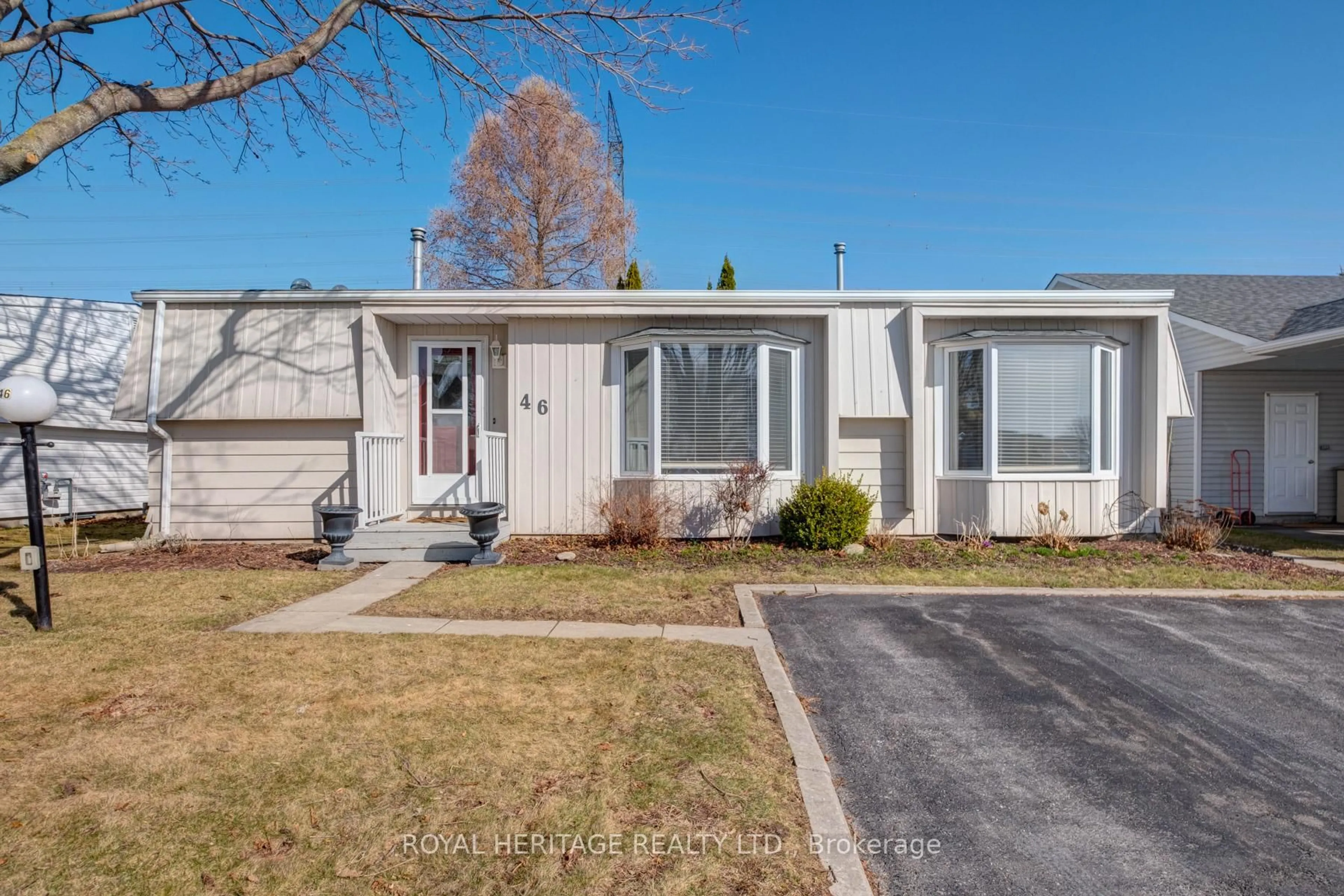 Home with vinyl exterior material, street for 46 Wilmot Tr, Clarington Ontario L1B 1B8