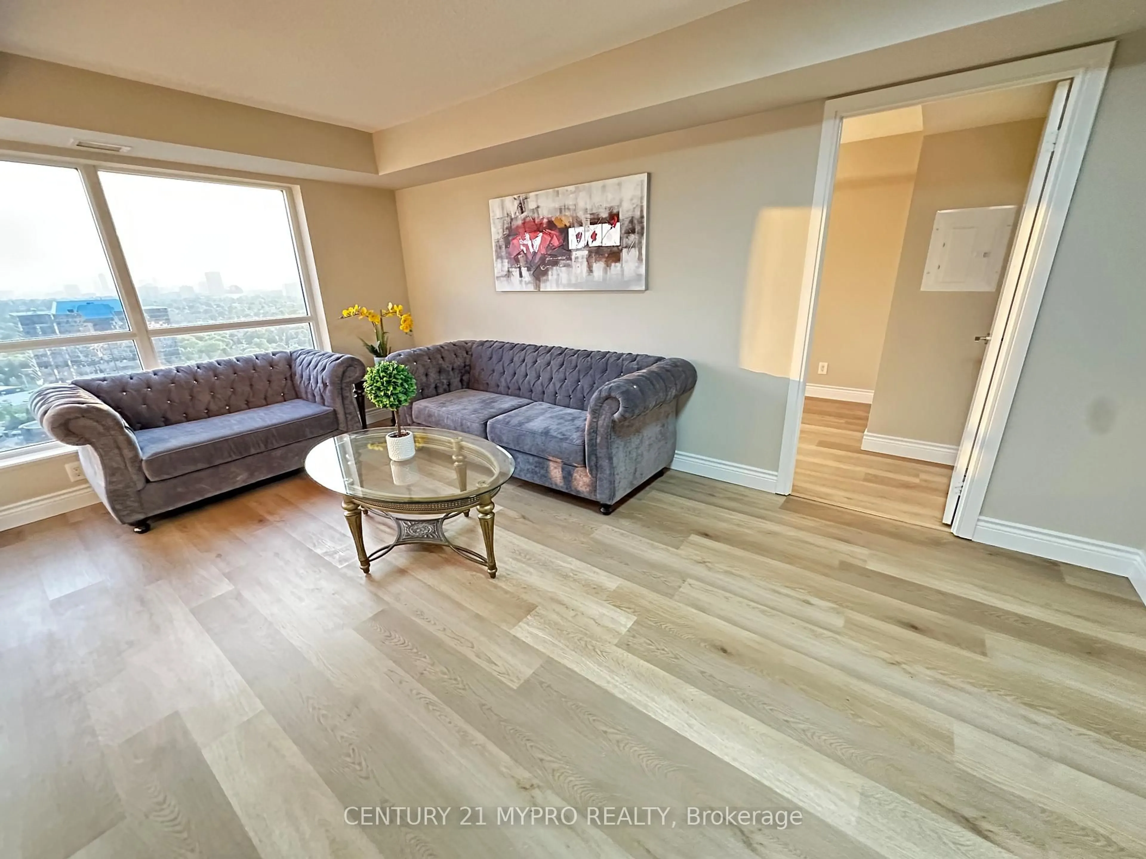 Living room with furniture, wood/laminate floor for 151 Village Green Sq #2506, Toronto Ontario M1S 0K5