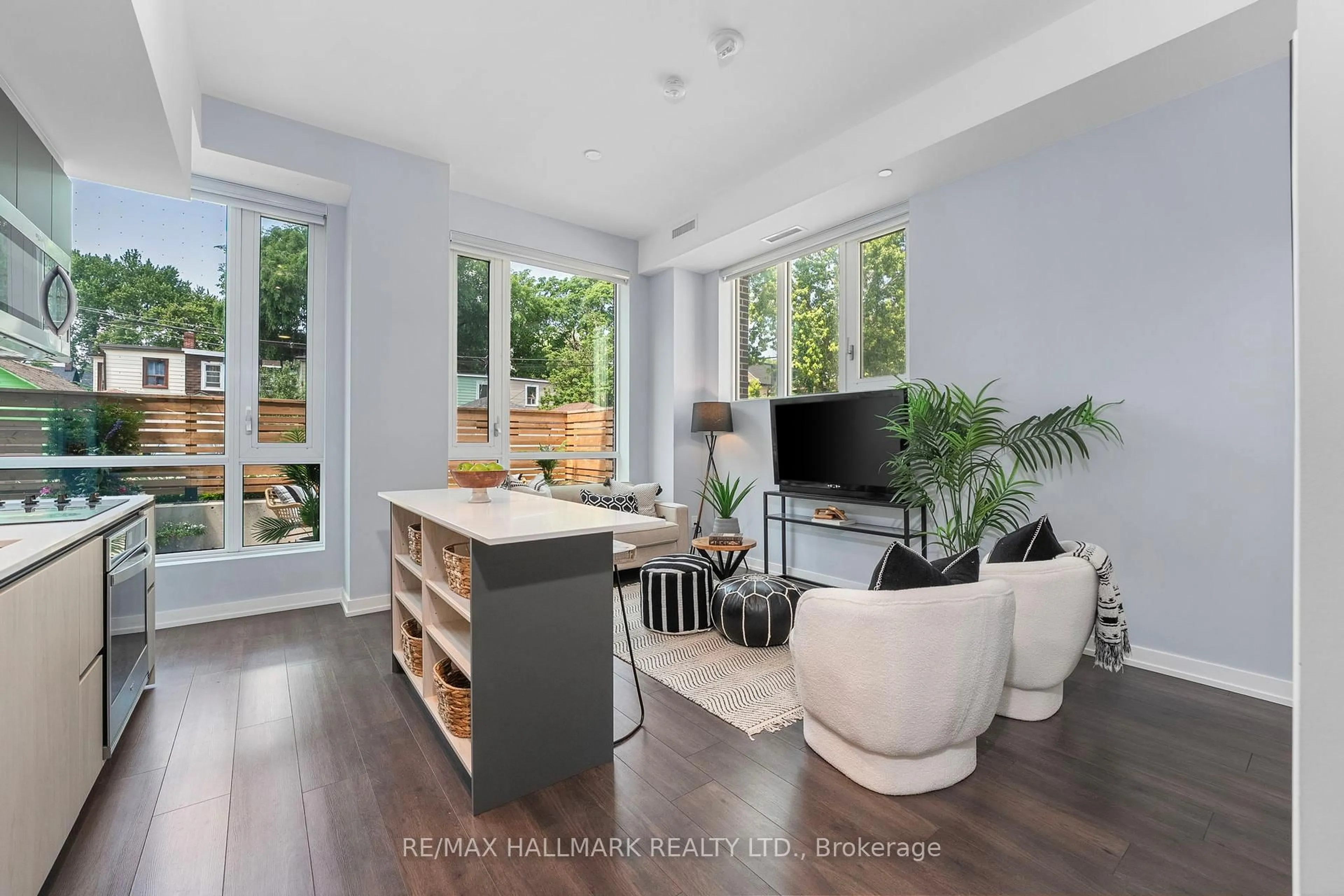 Living room with furniture, wood/laminate floor for 150 Logan Ave #124, Toronto Ontario M4M 0E4