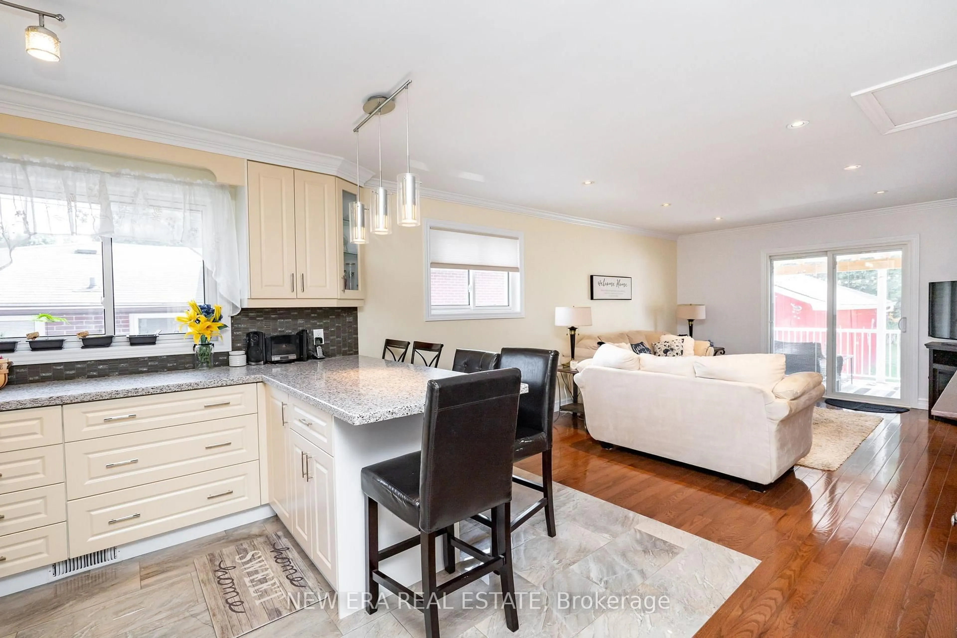 Open concept kitchen, wood/laminate floor for 258 Nipigon St, Oshawa Ontario L1J 4N7