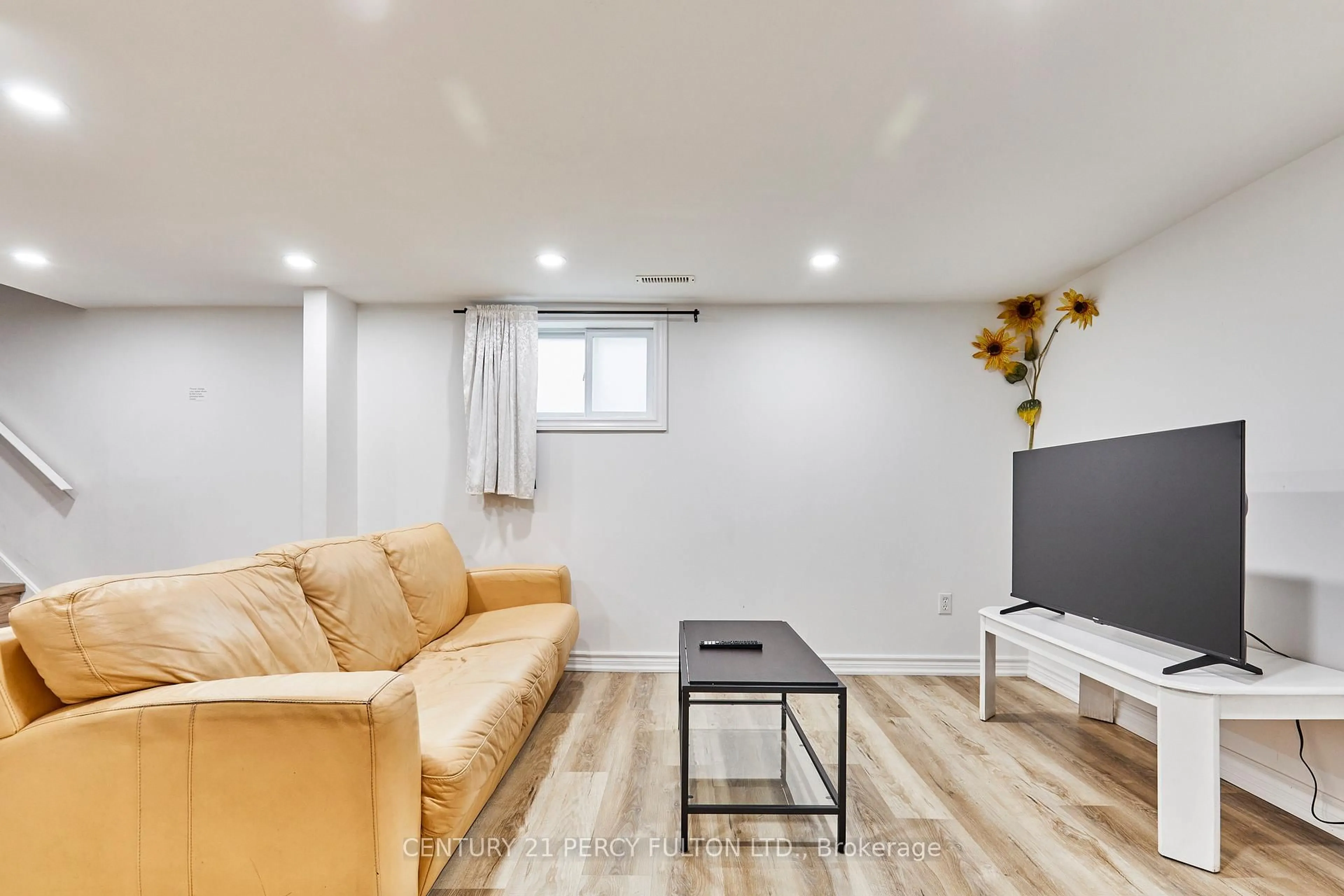 Living room with furniture, wood/laminate floor for 931 Liverpool Rd, Pickering Ontario L1W 1S7