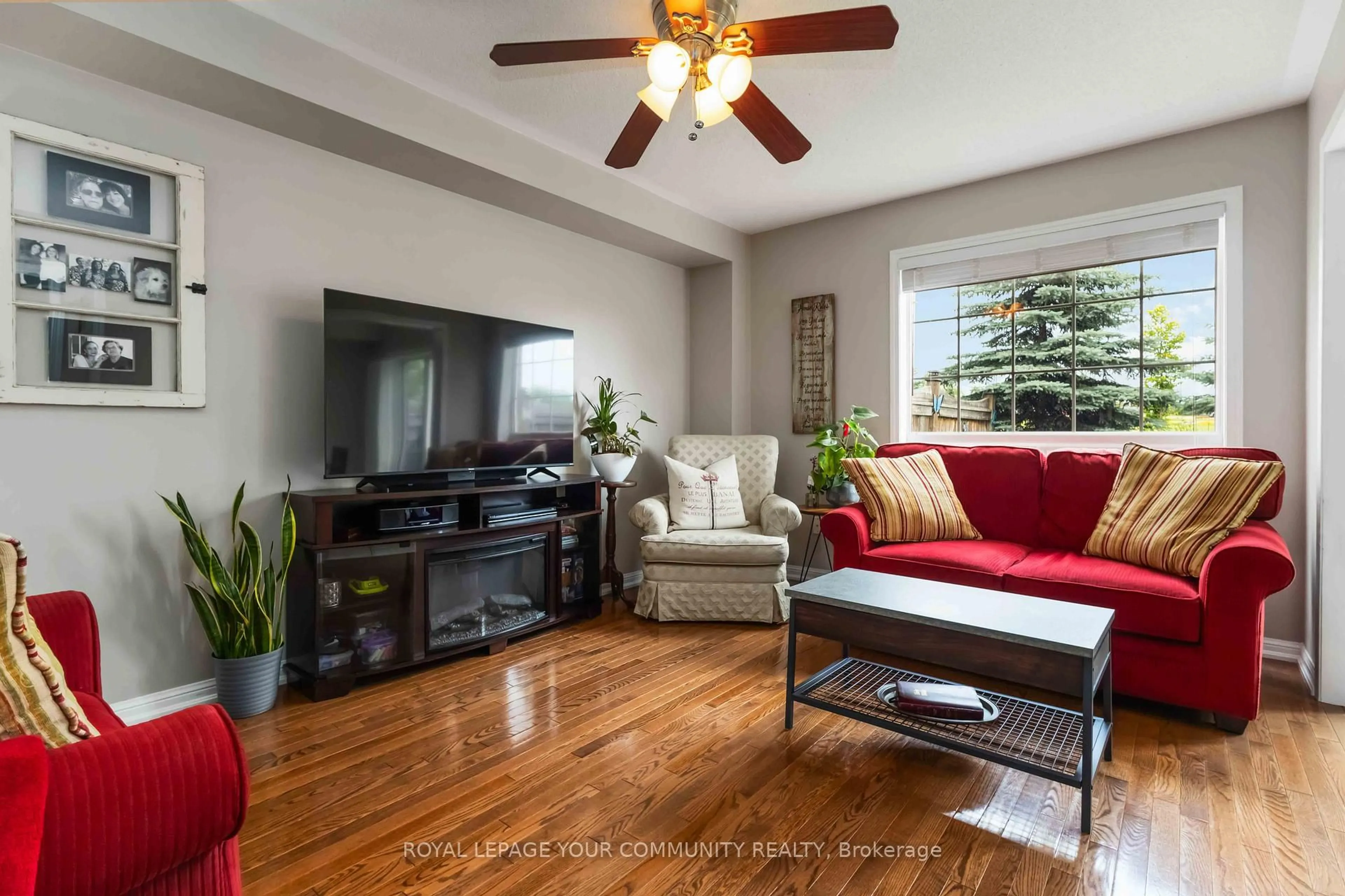 Living room with furniture, wood/laminate floor for 49 Latchford Way, Whitby Ontario L1N 9R3