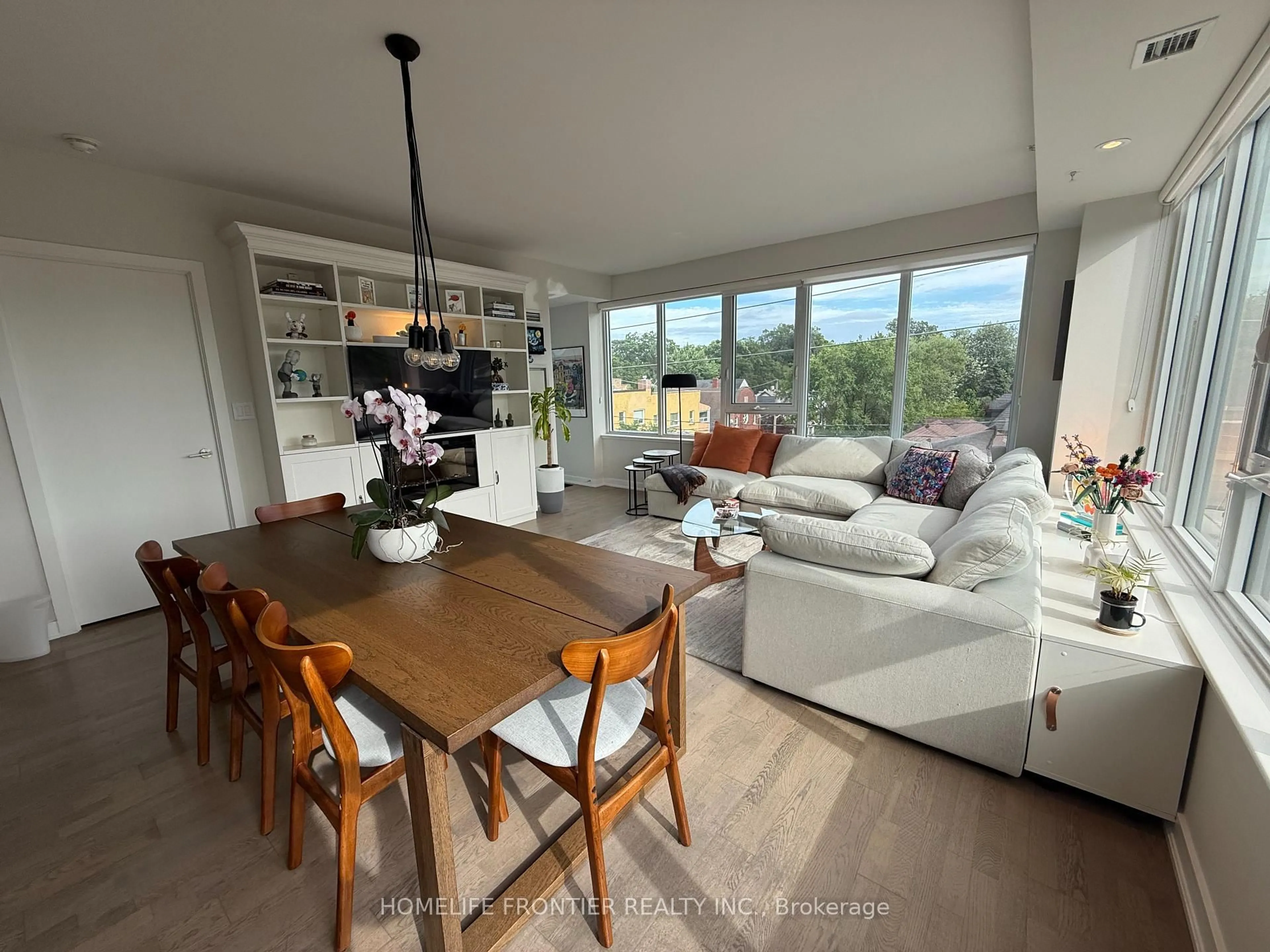 Living room with furniture, wood/laminate floor for 1960 Queen St #405, Toronto Ontario M4L 1H8