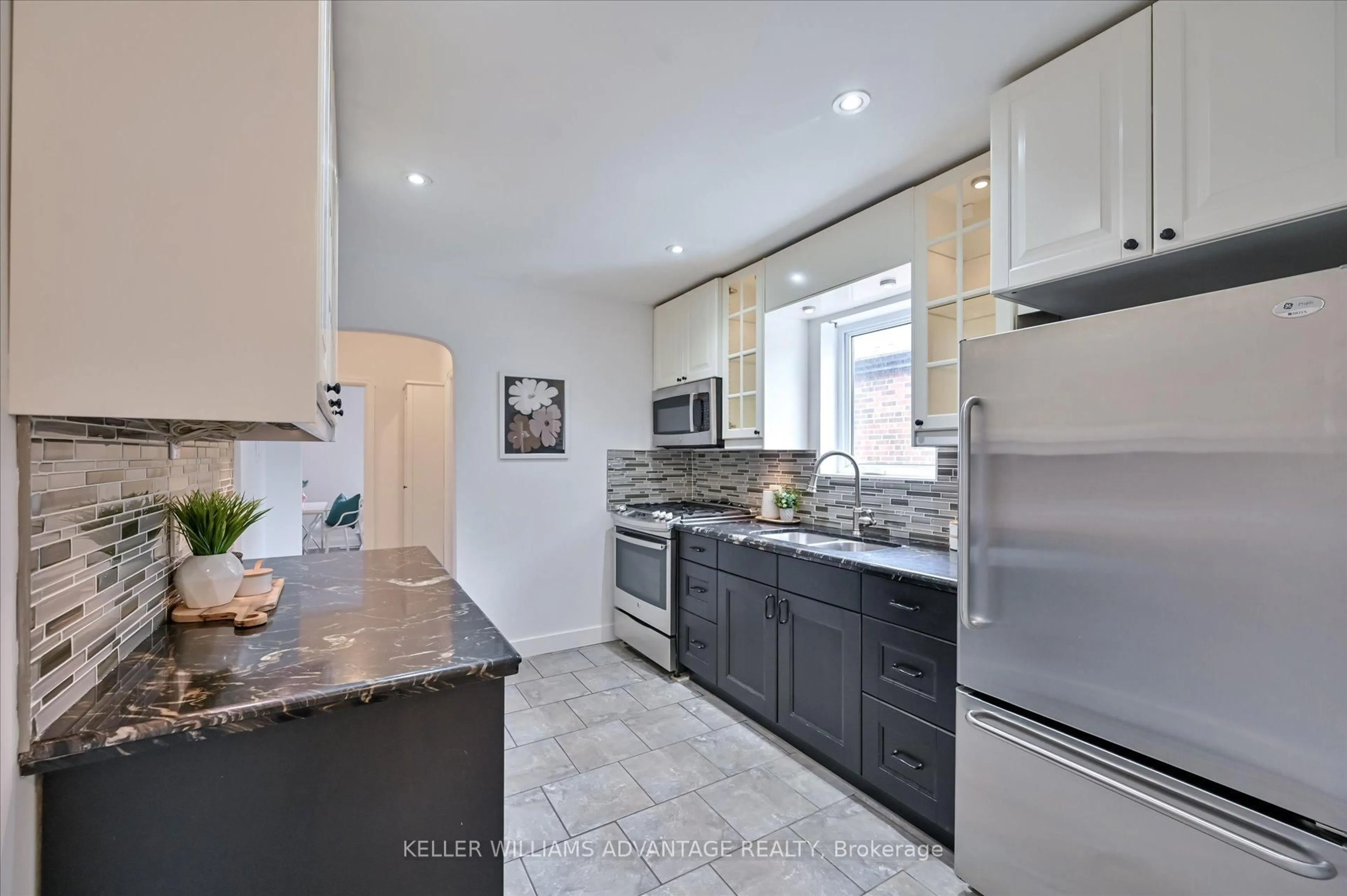 Open concept kitchen, ceramic/tile floor for 1080 Greenwood Ave, Toronto Ontario M4J 4E4