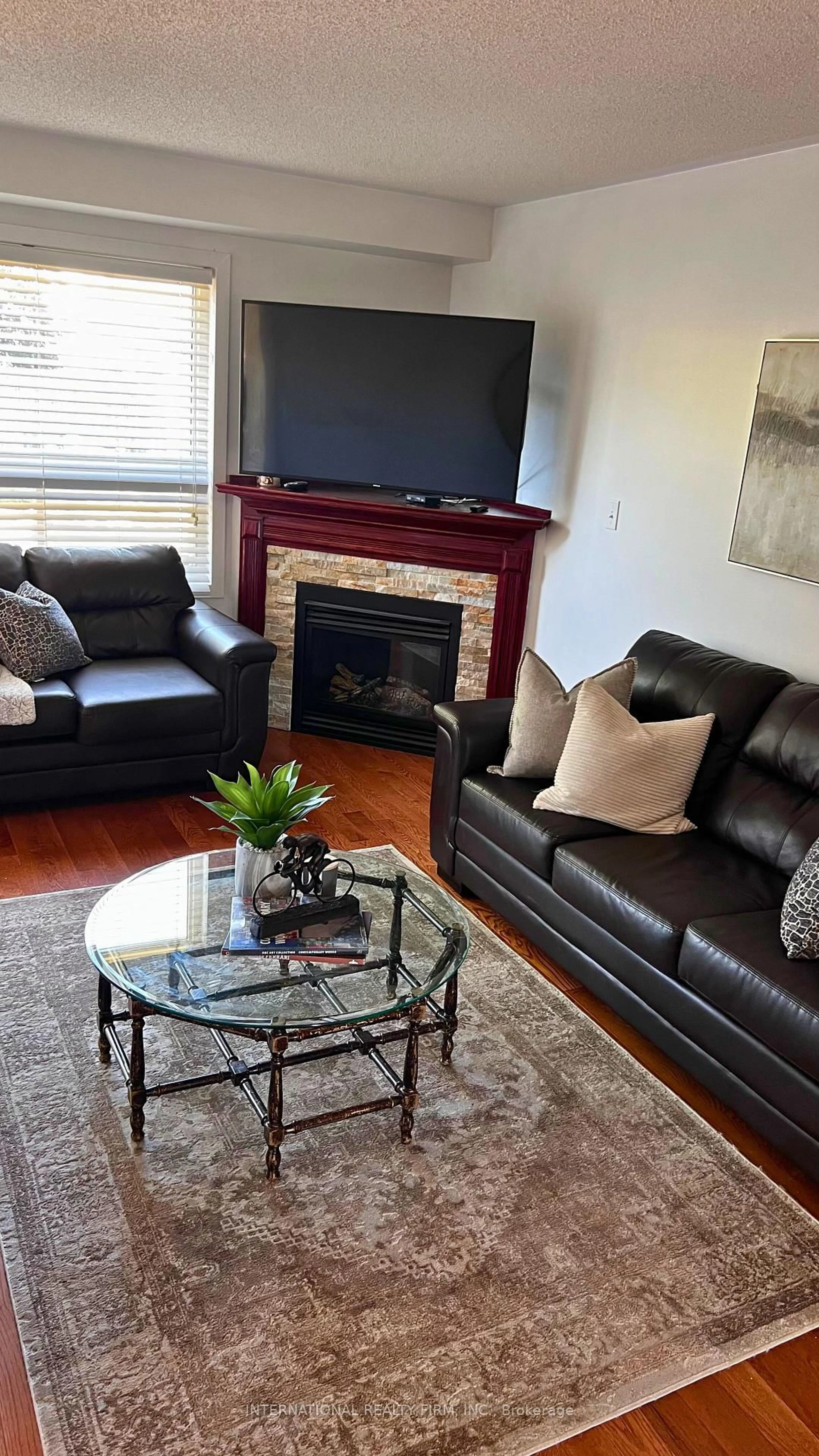 Living room with furniture, wood/laminate floor for 560 Falconridge Dr, Oshawa Ontario L1K 0C1