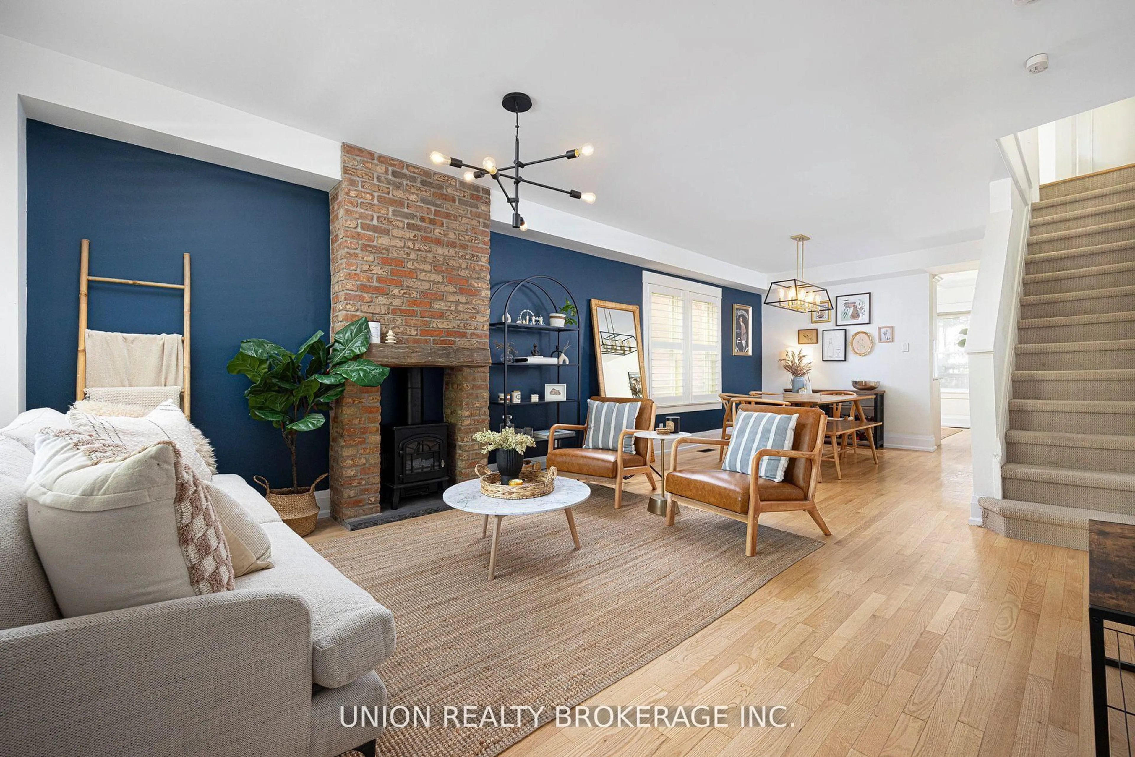Living room with furniture, wood/laminate floor for 152 Milverton Blvd, Toronto Ontario M4J 1V3