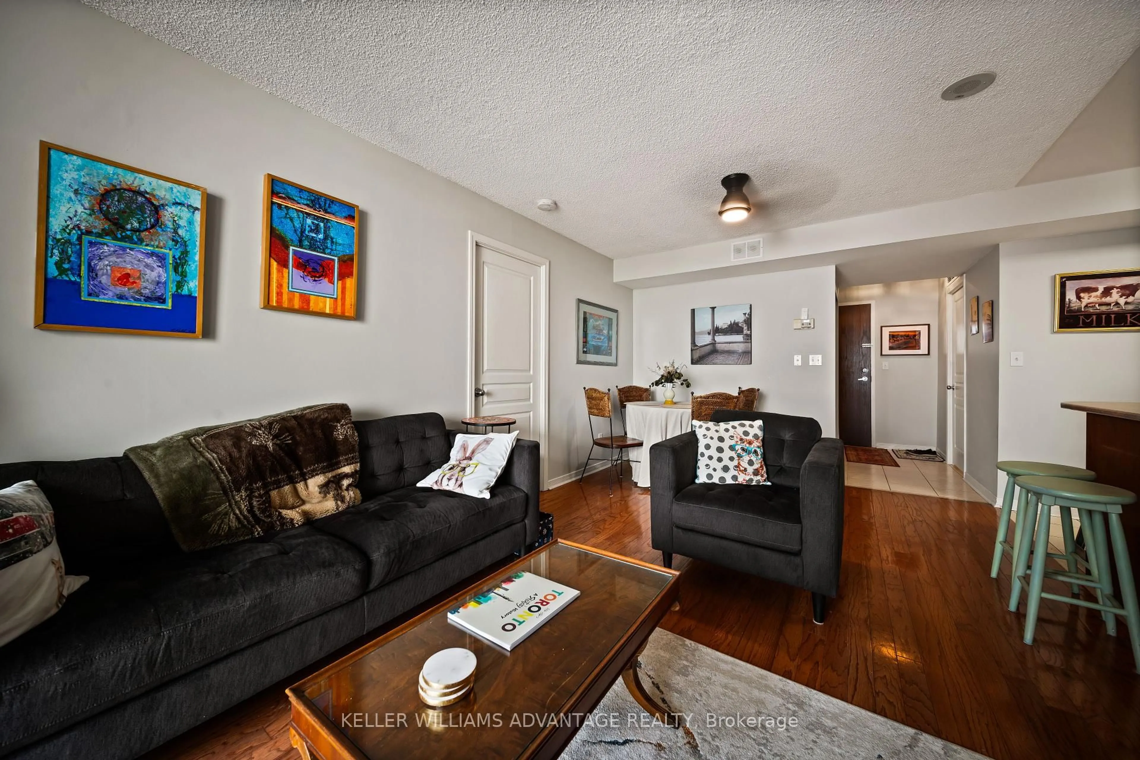 Living room with furniture, wood/laminate floor for 1765 Queen St #402, Toronto Ontario M4L 3Z2