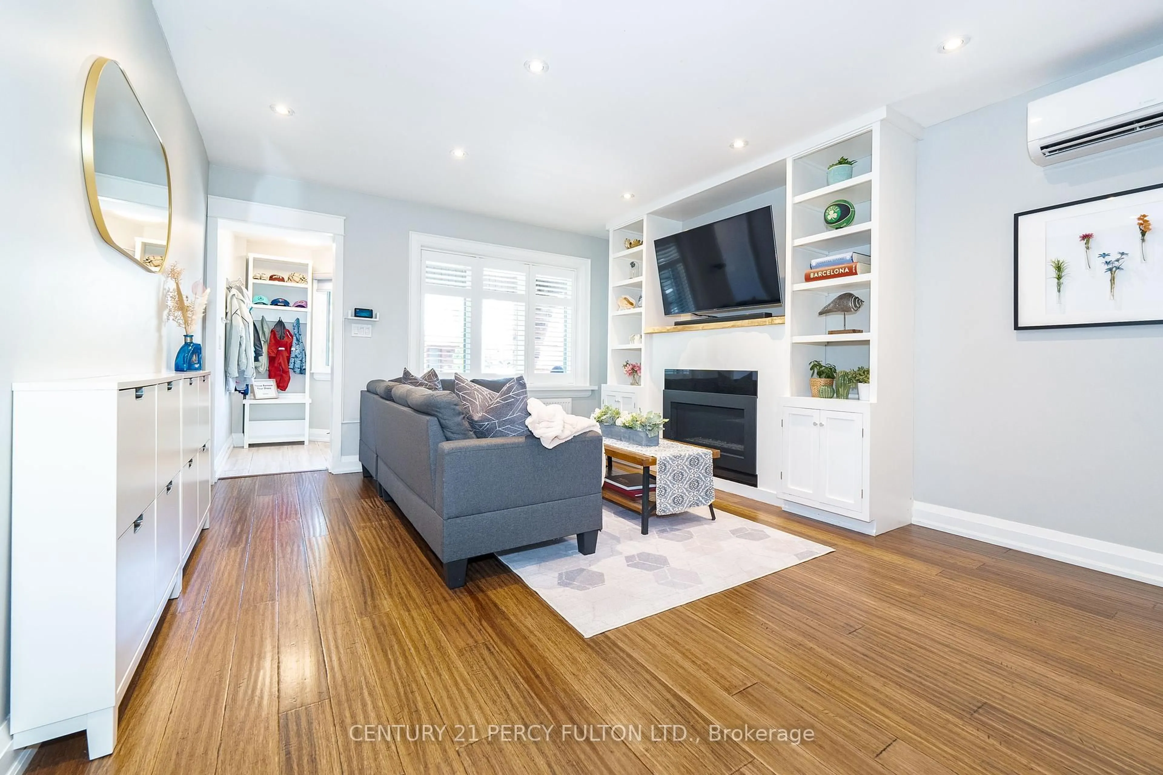 Living room with furniture, wood/laminate floor for 36 Marlow Ave, Toronto Ontario M4J 3T9