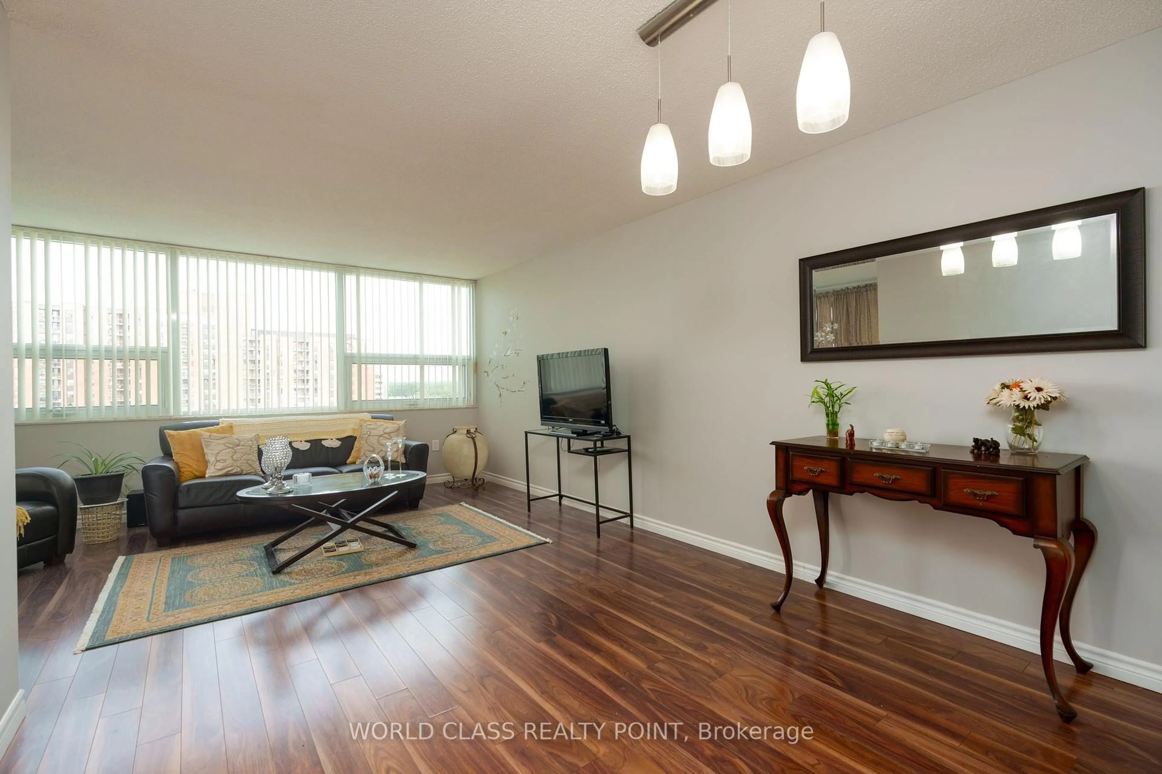 Living room with furniture, wood/laminate floor for 121 Ling Rd #1406, Toronto Ontario M1E 4Y2