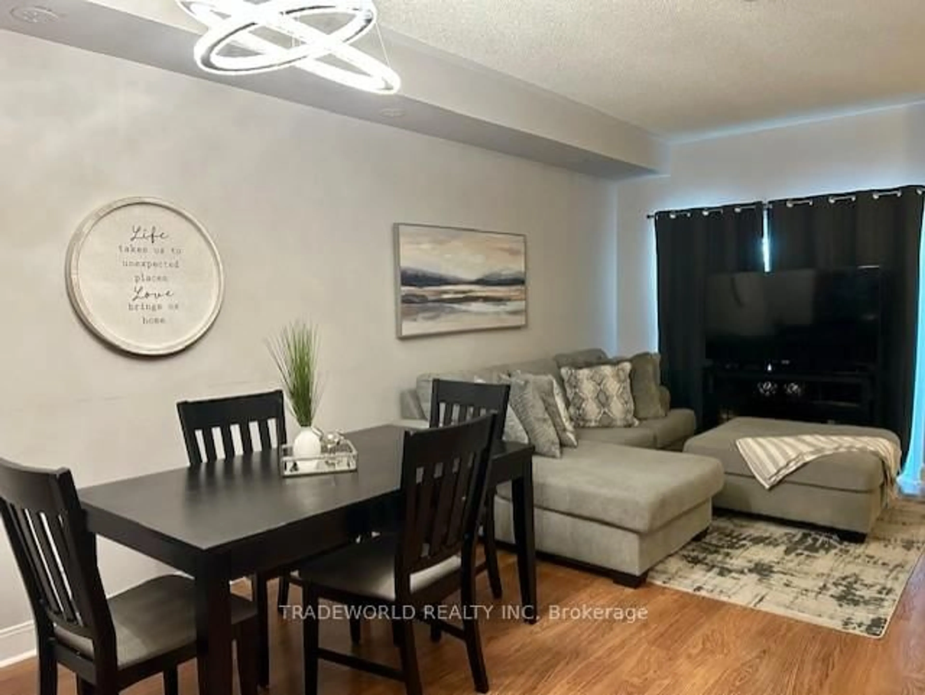 Living room with furniture, wood/laminate floor for 310 Village Green Sq #TH#38, Toronto Ontario M1S 0L1