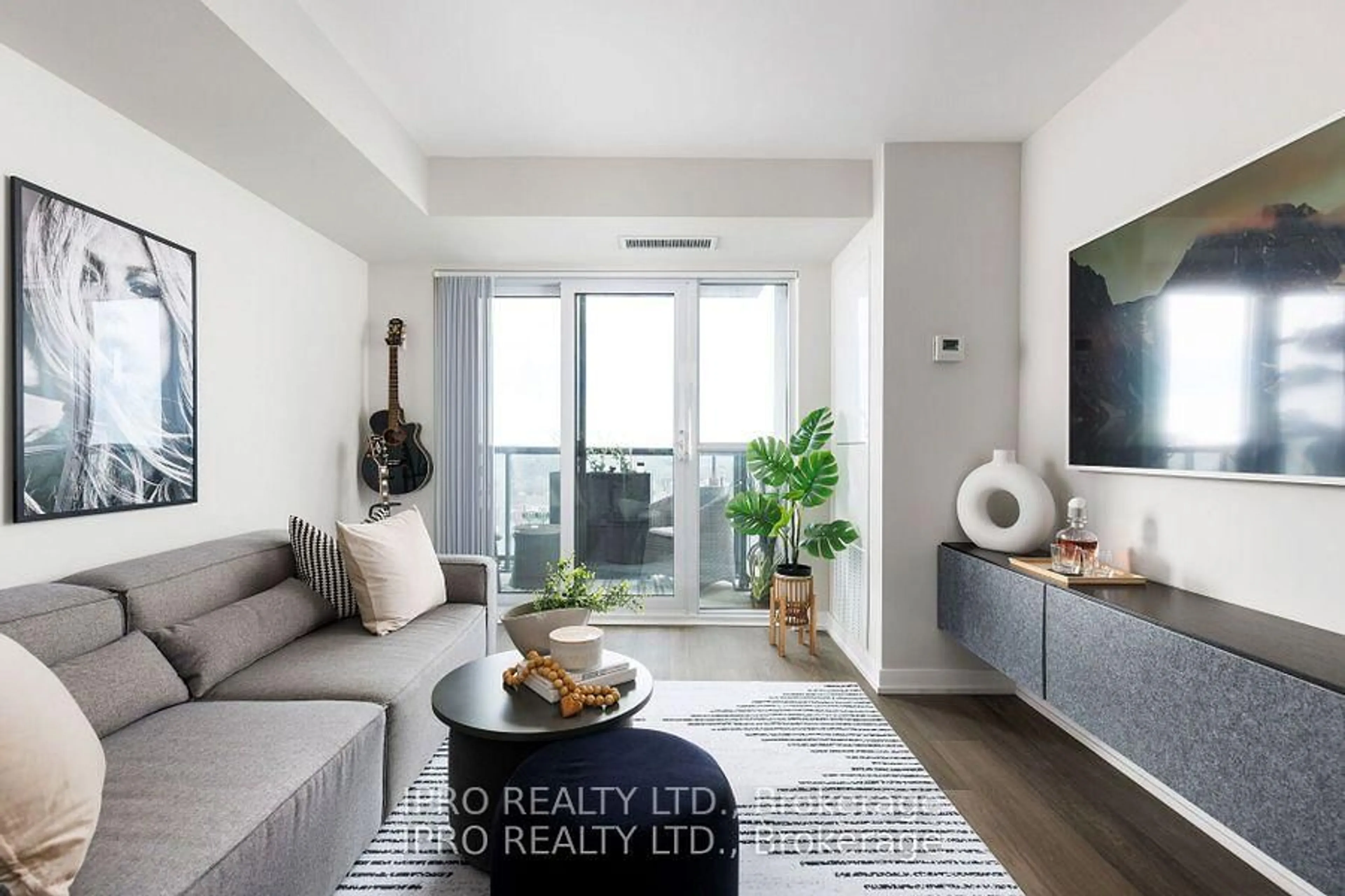 Living room with furniture, wood/laminate floor for 8 Trent Ave #1017, Toronto Ontario M4C 0A6