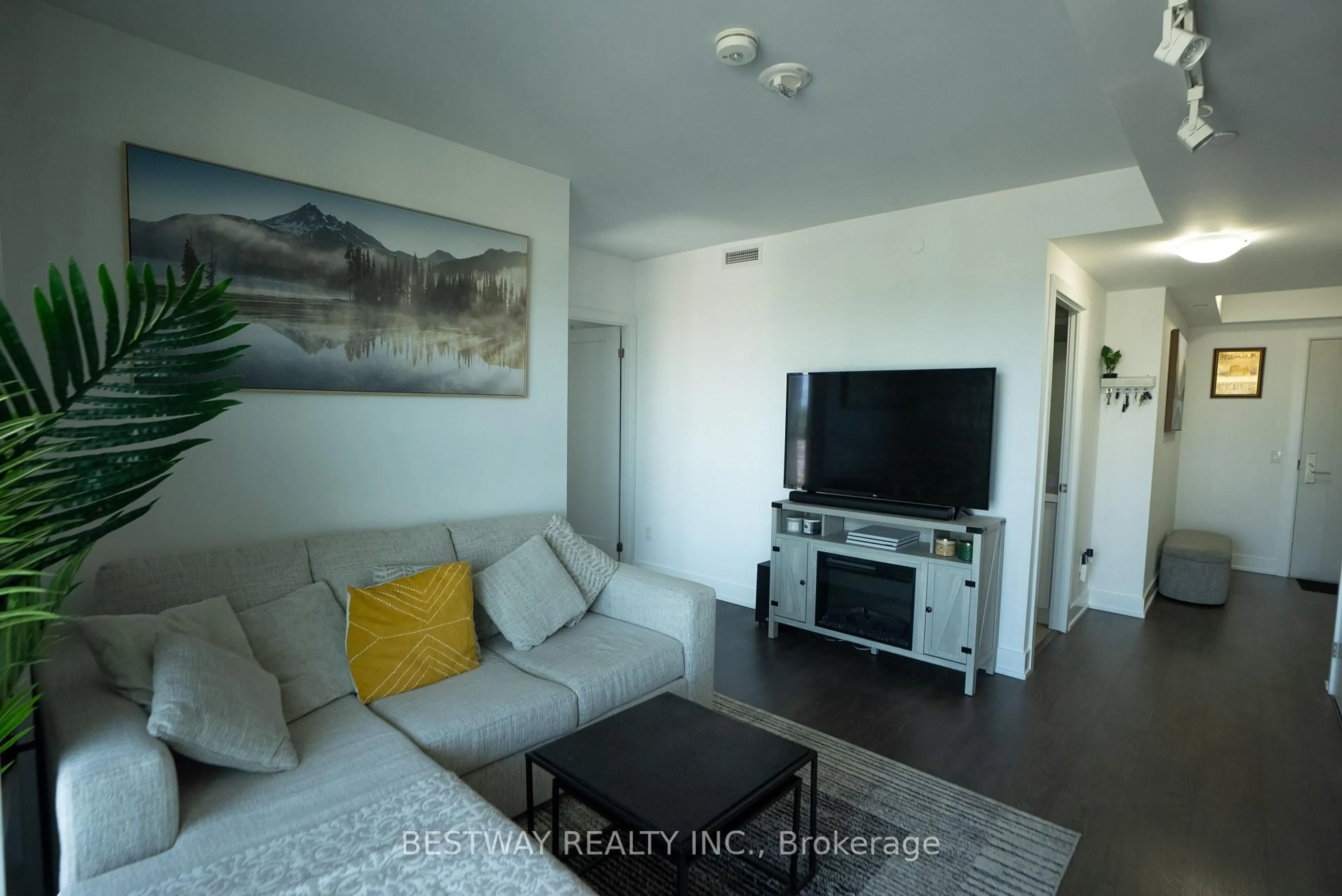 Living room with furniture, wood/laminate floor for 2550 Simcoe St #607, Oshawa Ontario L1L 0R5