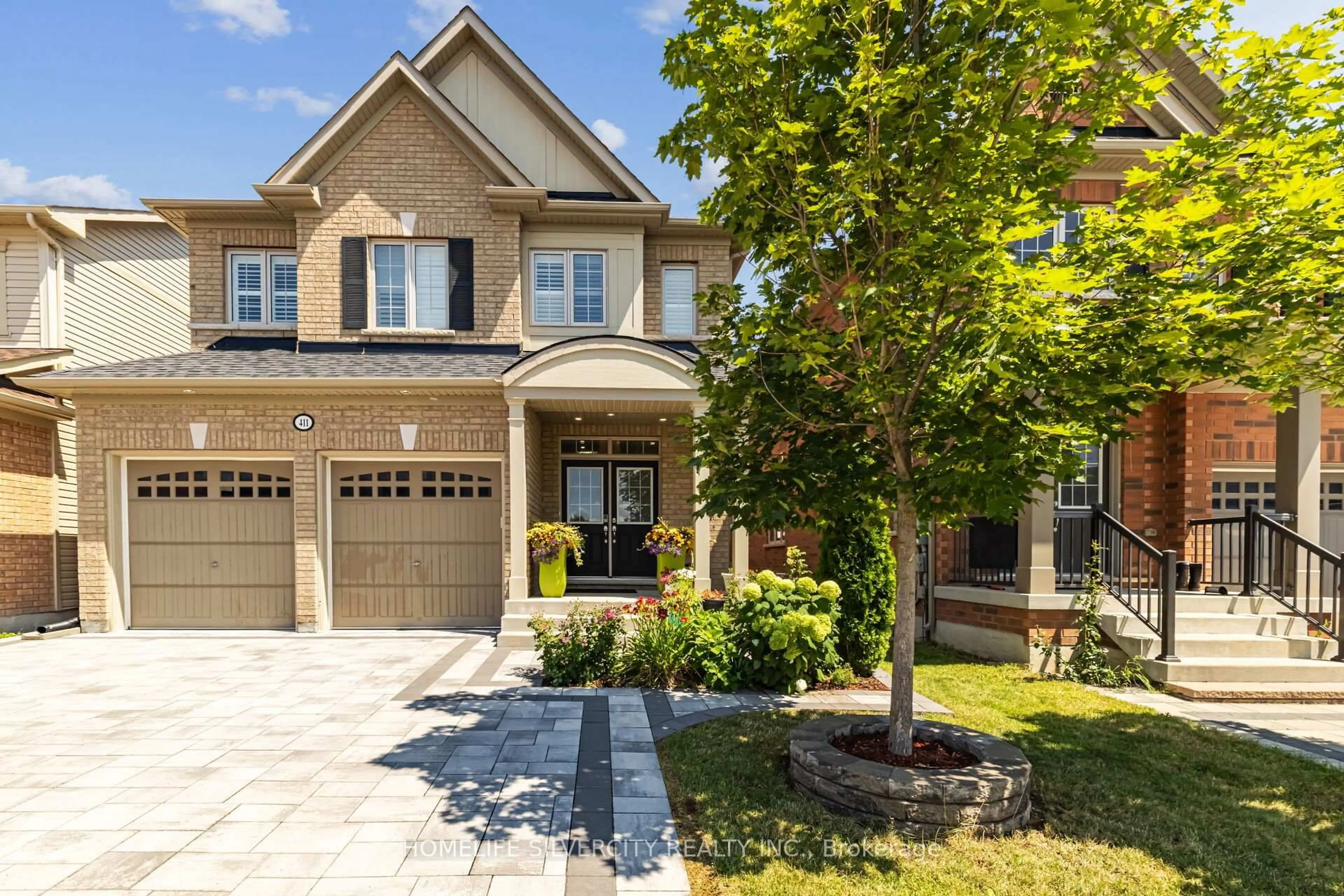 Home with brick exterior material, street for 411 Windfields Farm Dr, Oshawa Ontario L1L 0M1