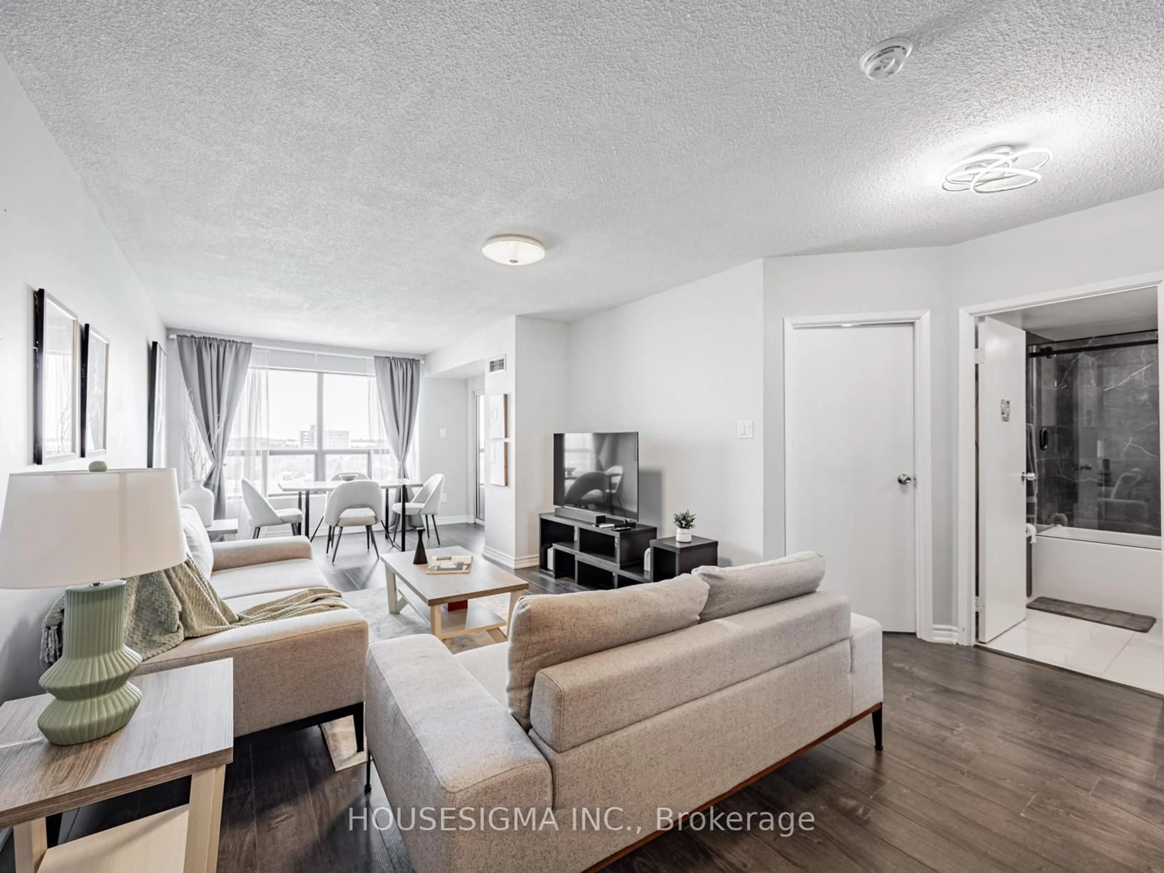 Living room with furniture, wood/laminate floor for 39 Kimbercroft Crt #703, Toronto Ontario M1S 5B5