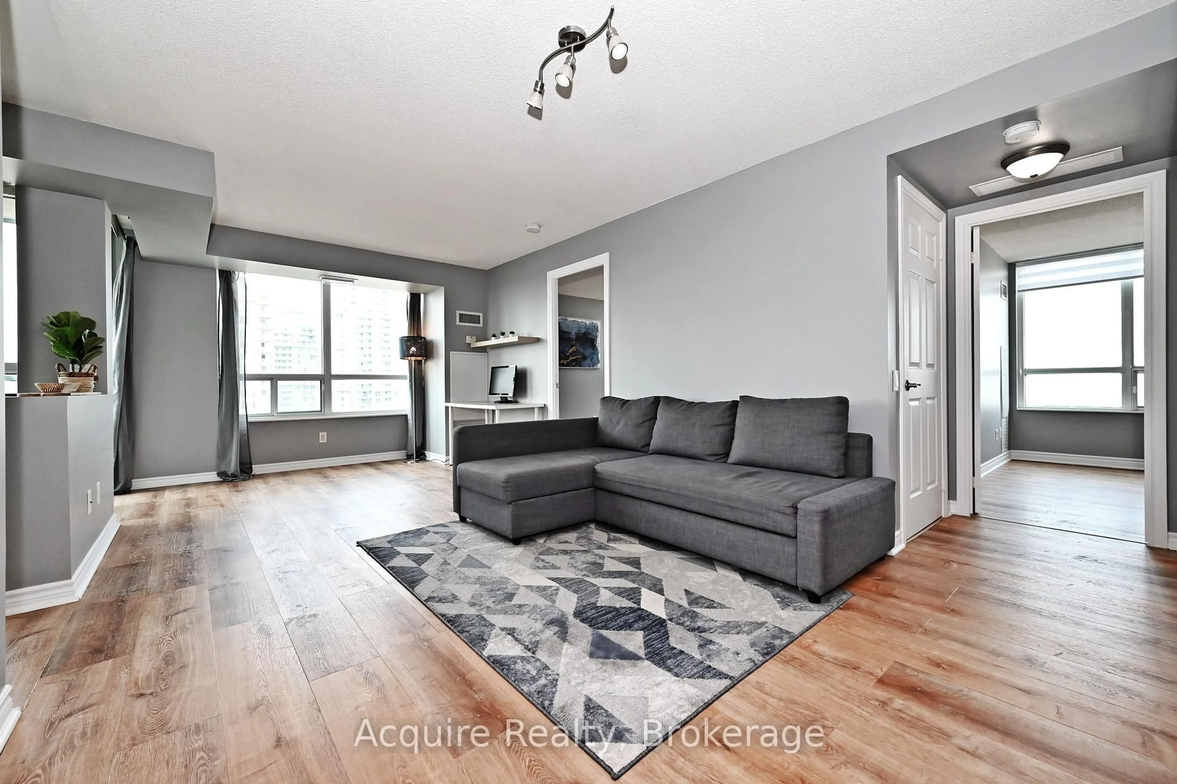 Living room with furniture, wood/laminate floor for 61 Town Centre Crt #2203, Toronto Ontario M1P 5C5